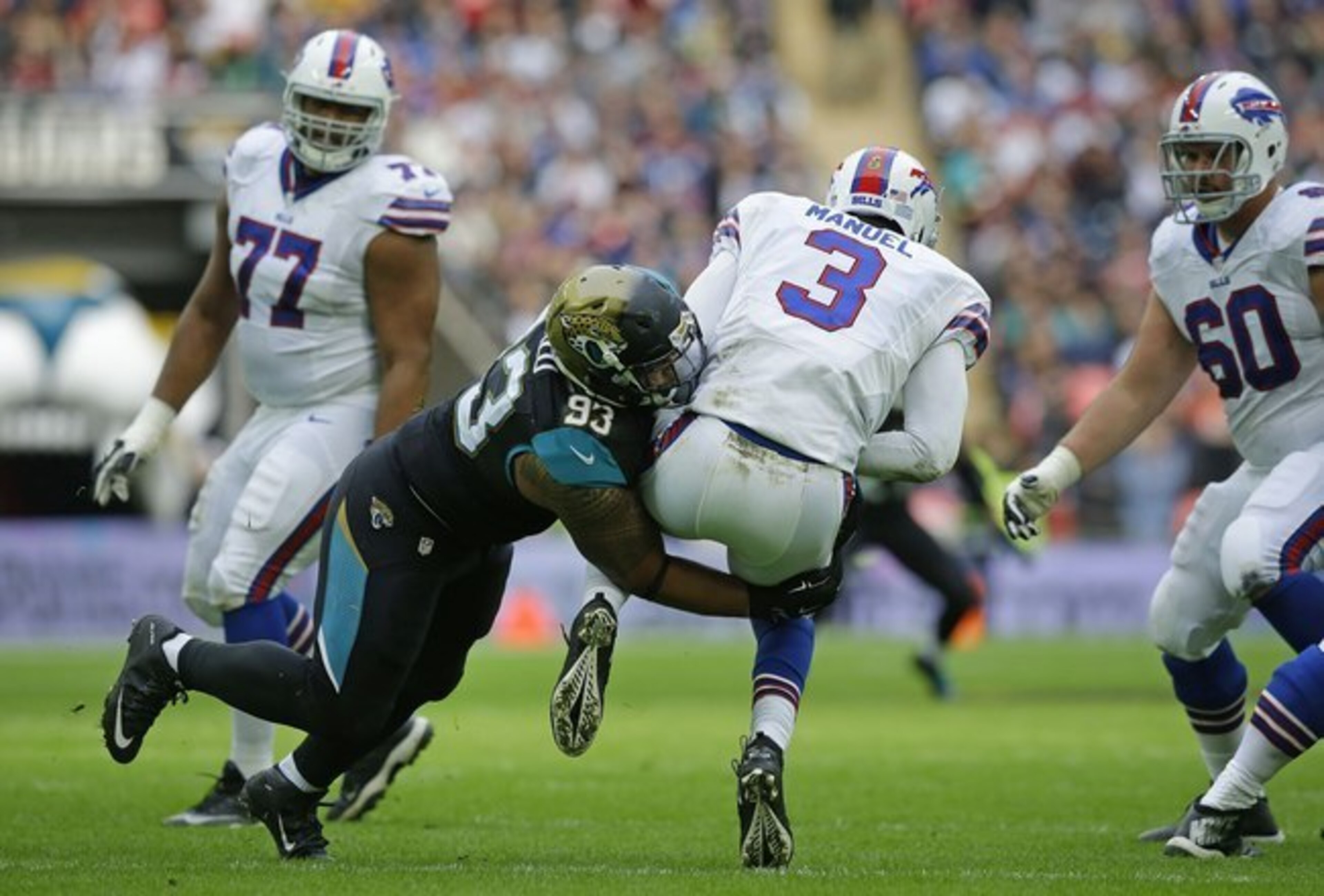 E.J. Manuel is hit during Sunday's game in England