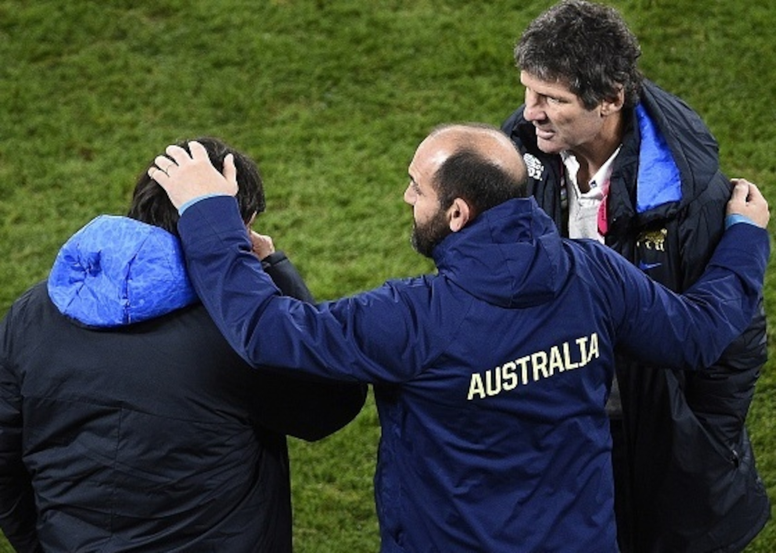 Australia's Argentinian forwards coach Mario Ledesma (C) embraces Argentina's head coach Daniel Hourcade (L) after winning a  semi-final match of the 2015 Rugby World Cup between Argentina and Australia at Twickenham Stadium, southwest London, on October 