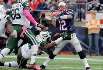 Sheldon Richardson forces a fumble of Patriots quarterback Tom Brady.