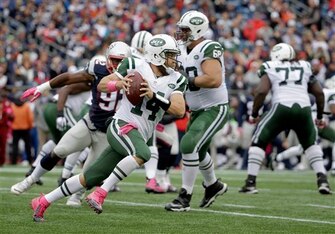 Ryan Fitzpatrick looks for room to run against the New England Patriots.