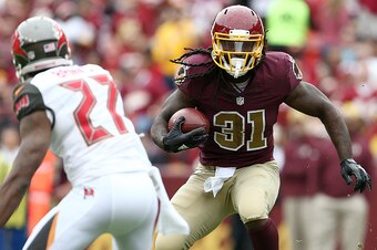 LANDOVER, MD - OCTOBER 25: Running back Matt Jones #31 of the Washington Redskins carries the ball while cornerback Johnthan Banks #27 of the Tampa Bay Buccaneers defends in the second quarter of a game at FedExField on October 25, 2015 in Landover, Maryl