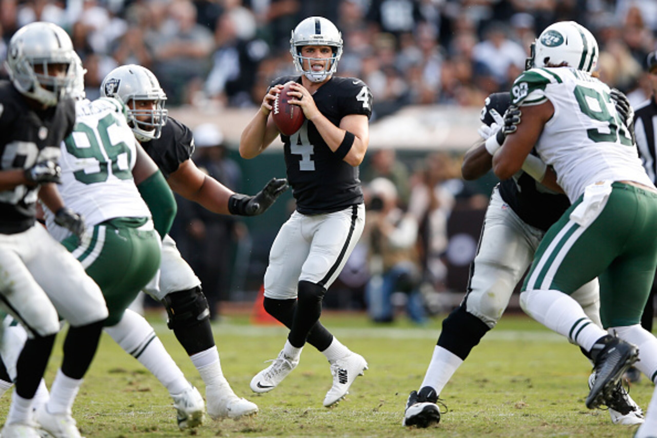Raiders quarterback Derek Carr looks downfield. Raiders quarterback Derek Carr looks downfield.