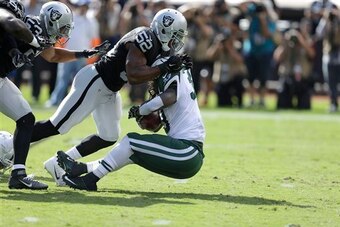 Chris Ivory is tackled for a loss by Khalil Mack.