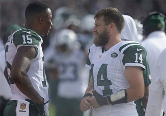 Ryan Fitzpatrick (right) talks with Brandon Marshall (left). Fitzpatrick injured his thumb in the game.