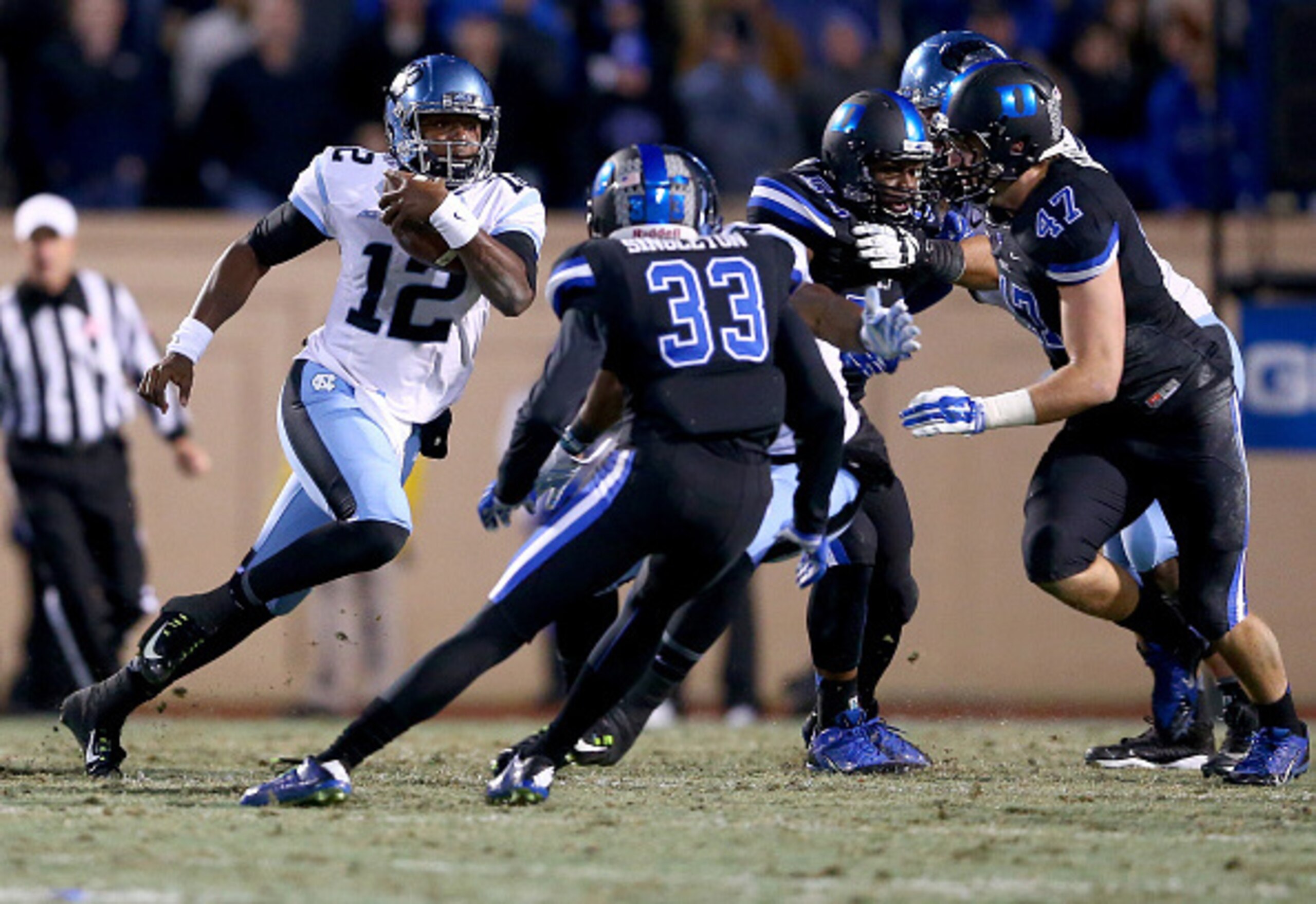 DURHAM, NC - NOVEMBER 20:  Marquise Williams #12 of the North Carolina Tar Heels runs with the ball against the Duke Blue Devils during their game at Wallace Wade Stadium on November 20, 2014 in Durham, North Carolina.  (Photo by Streeter Lecka/Getty Imag