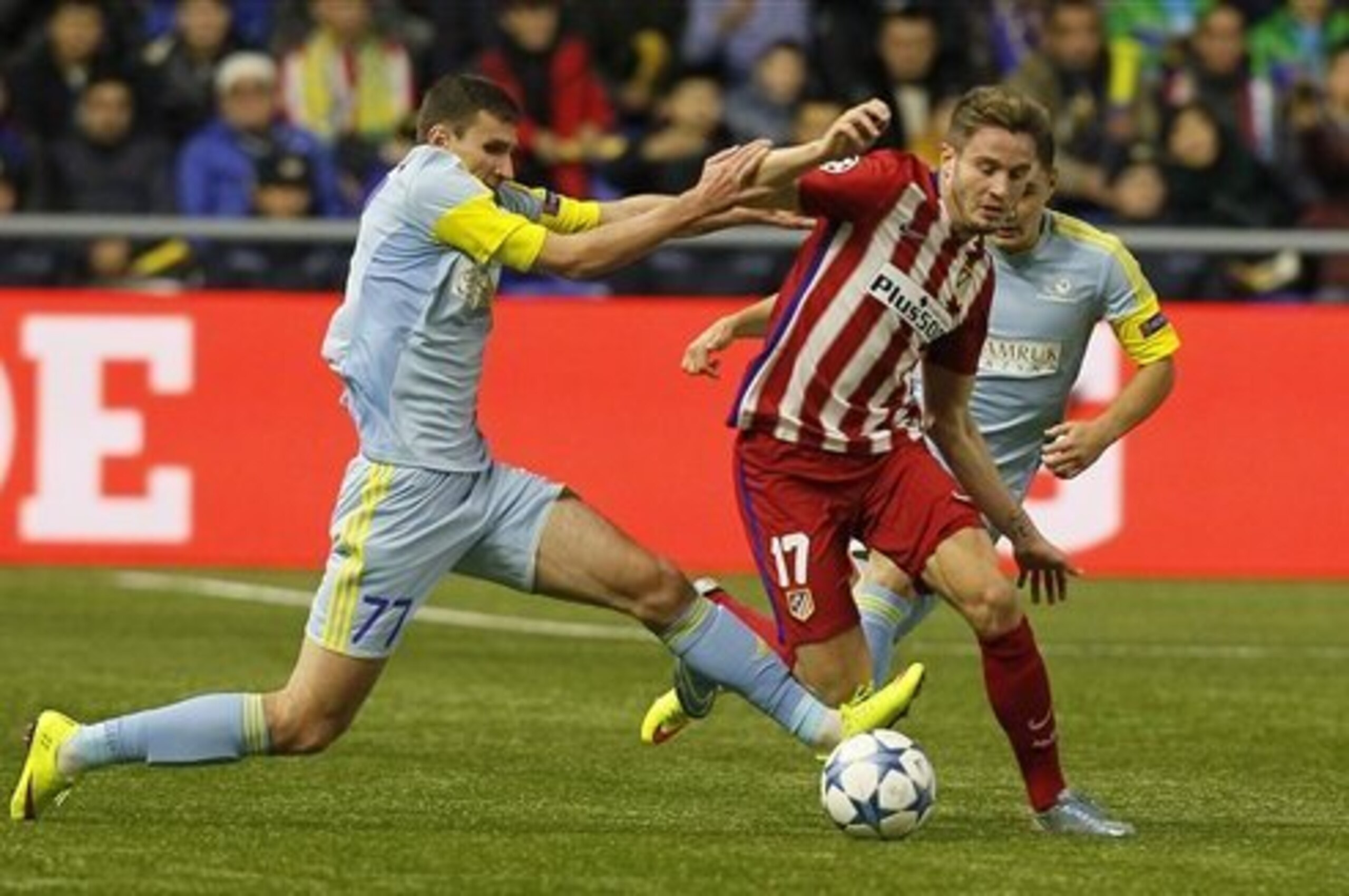 Astana's Dmitry Shomko, left, and Atletico Madrid's Saul Niguez  fight for the ball during a Champions League Group C soccer match  in Astana, Kazakhstan, Tuesday, Nov. 3, 2015. (AP Photo/Alexey Filippov)