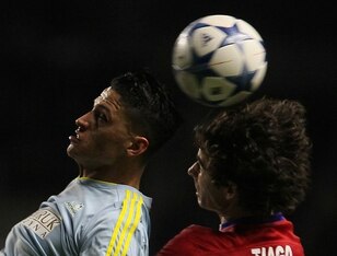 Astana's Colombian midfielder Roger Henao Canas (L) vies for the ball with Atletico Madrid's Portuguese midfielder Tiago during the UEFA Champions League group C football match between FC Astana and Club Atletico de Madrid at the Astana Arena stadium in A