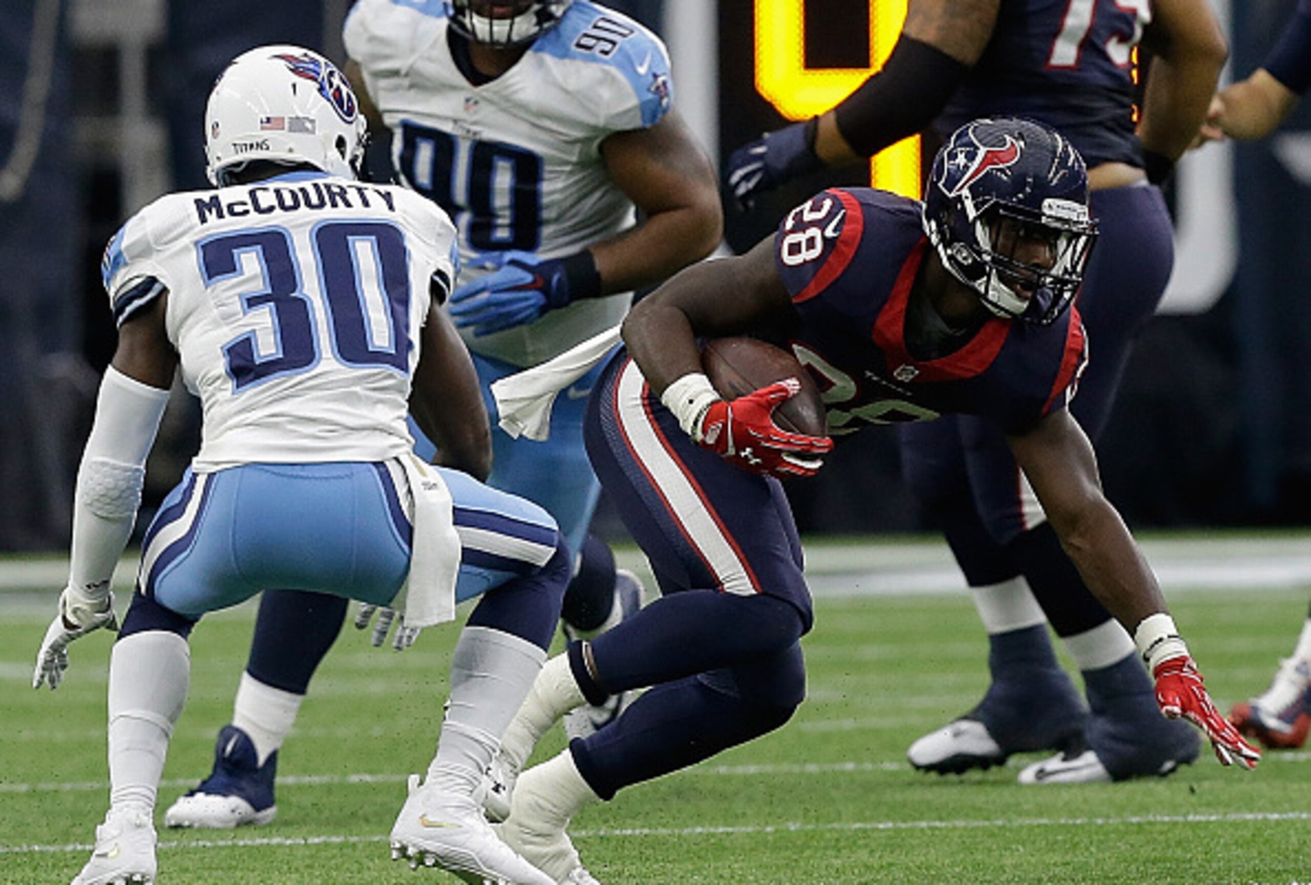 Jason McCourty looks to defend Texans RB Alfred Blue (right).