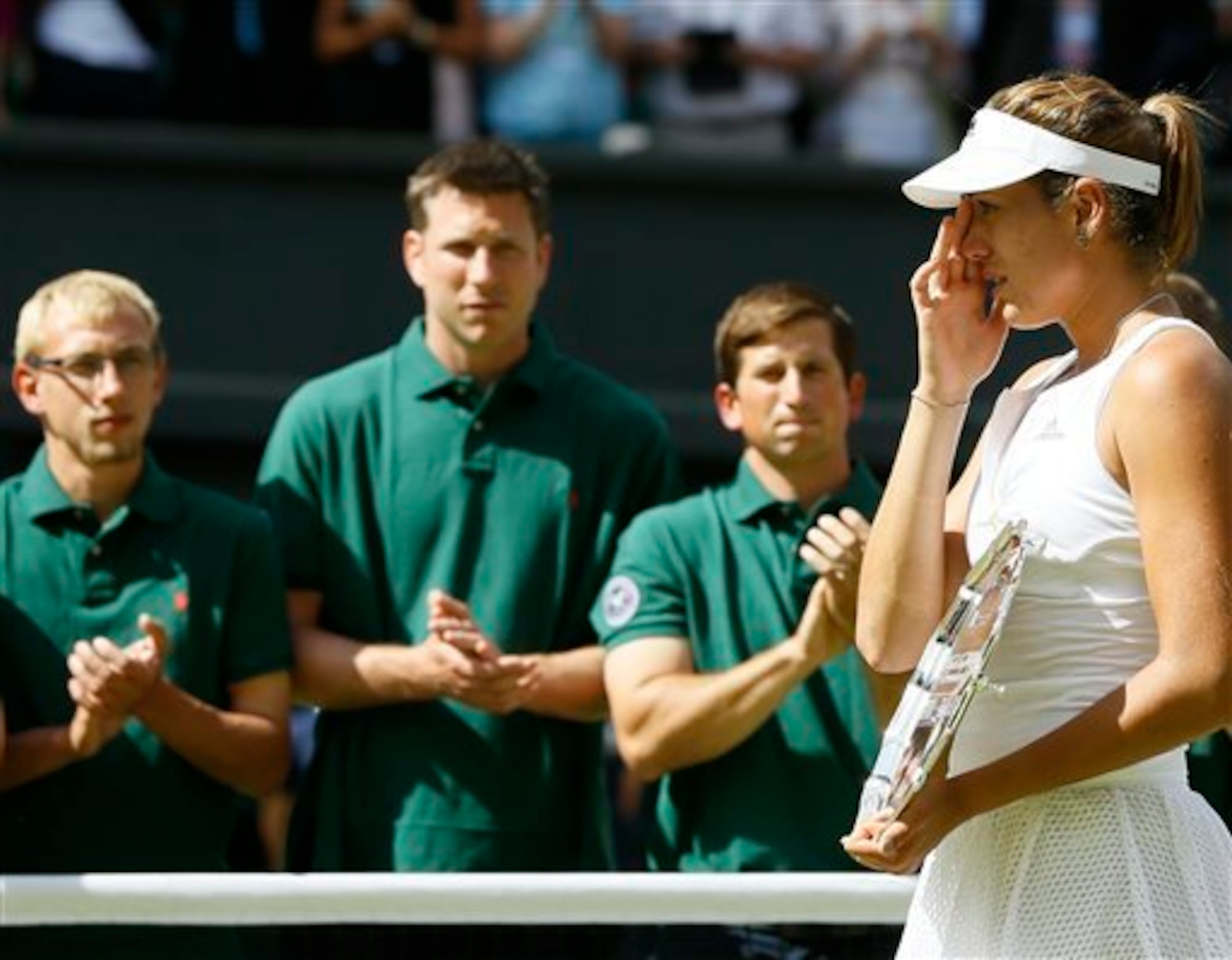 Garbine Muguruza wipes away tears during the trophy ceremony at Wimbledon.