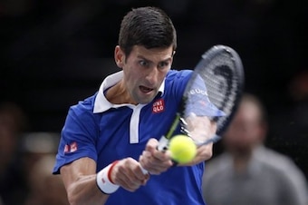 Novak Djokovic hits a backhand during a match at the Paris Masters.