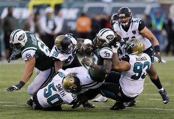 Chris Ivory is tackled by three Jaguar defenders
