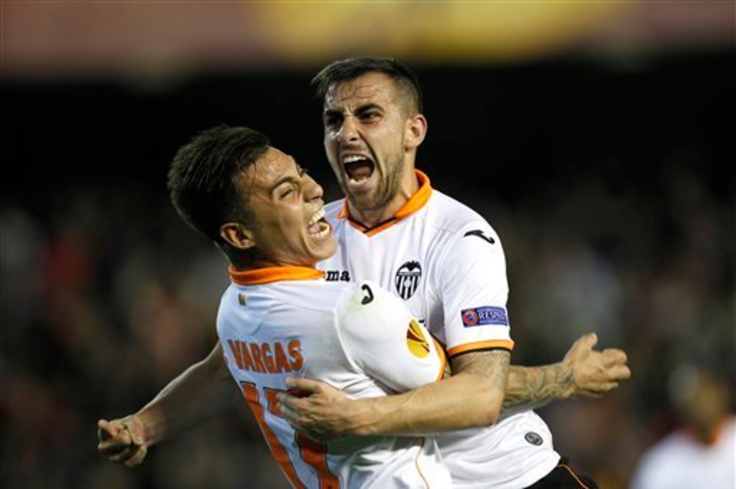 Valencia’s Paco Alcacer, right, celebrates with Eduardo Vargas from Chile after scoring against Basel during the Europa League quarterfinal, second leg soccer match at the Mestalla stadium in Valencia, Spain, on Thursday, April 10, 2014. Valencia lost 3-0
