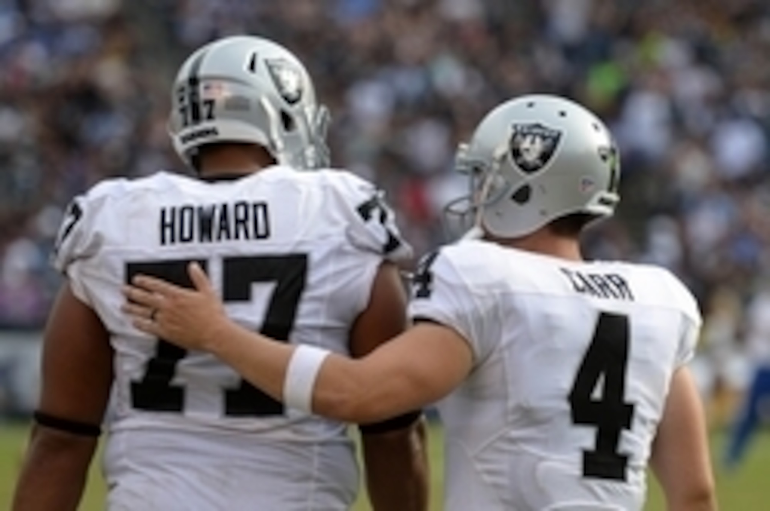 Oct 25, 2015; San Diego, CA, USA; Oakland Raiders quarterback Derek Carr (4) pats offensive tackle Austin Howard (77) on the back during the fourth quarter against the San Diego Chargers at Qualcomm Stadium. Mandatory Credit: Jake Roth-USA TODAY Sports