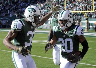 Marcus Williams (20) celebrates with Antonio Cromartie (31) after intercepting a pass.