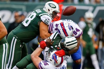 Mario Williams and Kyle Williams sack Michael Vick.