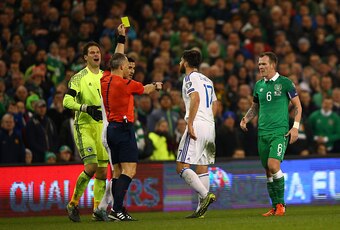 DUBLIN, IRELAND - NOVEMBER 16:  Emilijus Zubas of Bosnia and Herzegovina is shown the yellow card by referee Bjorn Kuipers of Netherlands during the UEFA EURO 2016 Qualifier play off, second leg match between Republic of Ireland and Bosnia and Herzegovina