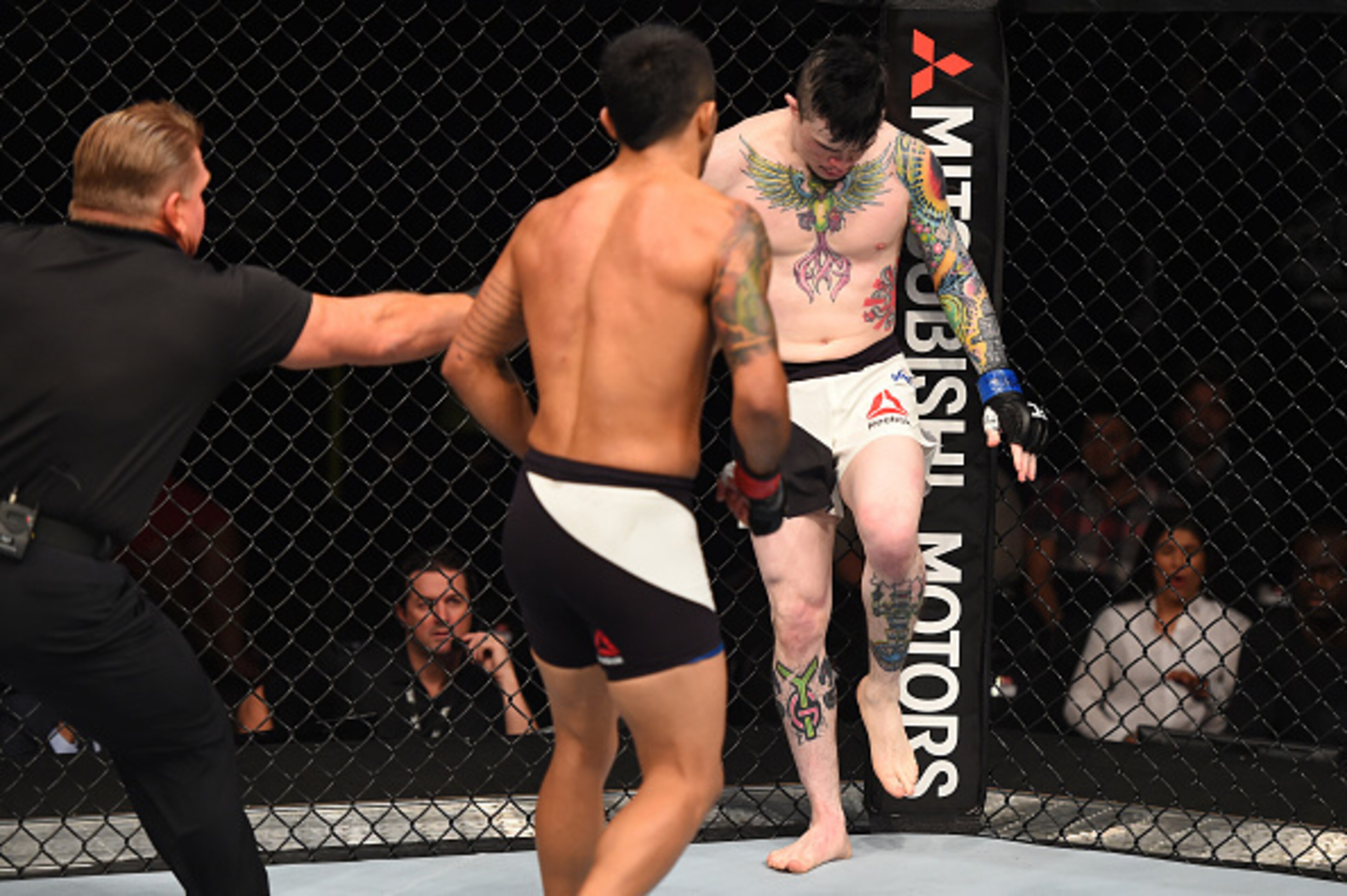 Gary Copeland (left) fails to intervene as Scott Jorgensen attempts to fight with one leg.
