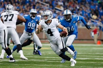 Ziggy Ansah (No. 94) chasing down Raiders quarterback Derek Carr.