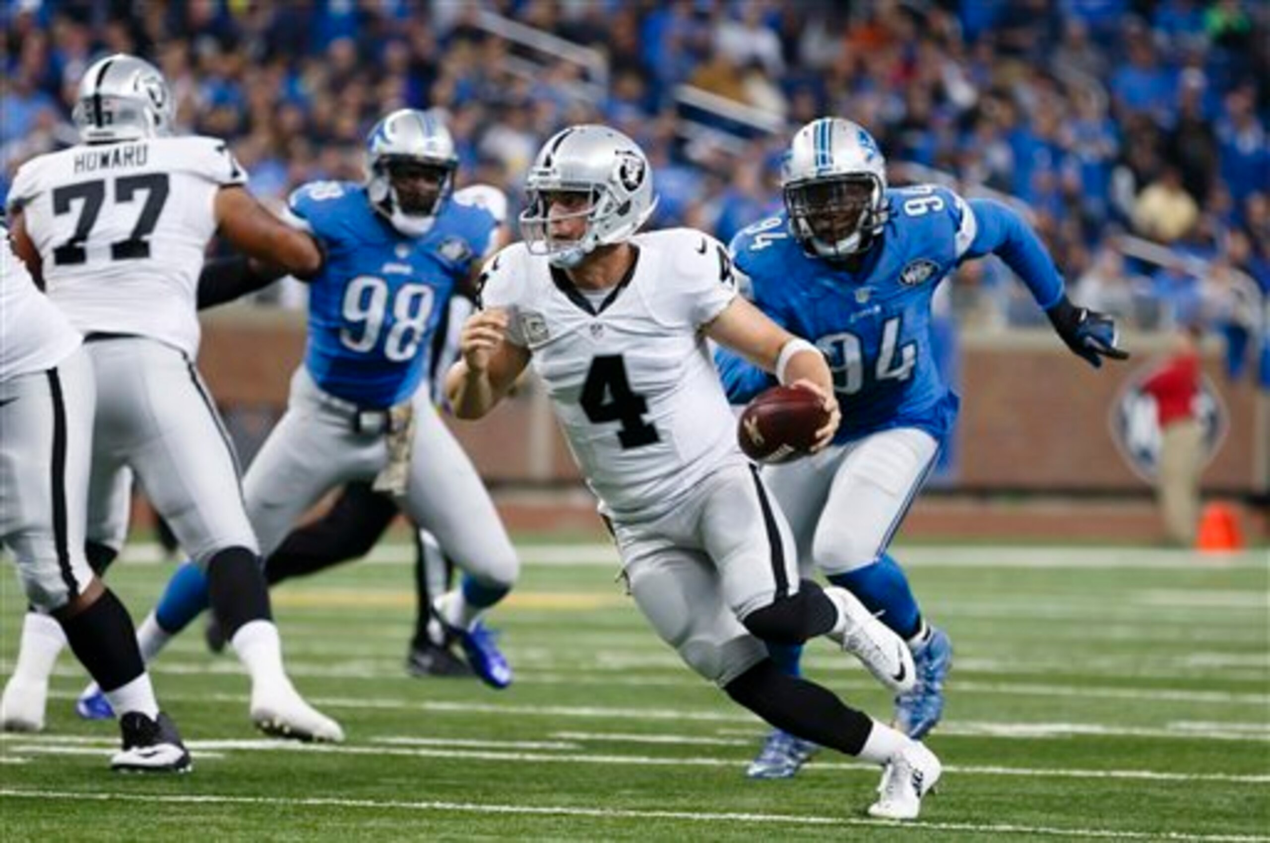 Ziggy Ansah (No. 94) chasing down Raiders quarterback Derek Carr.