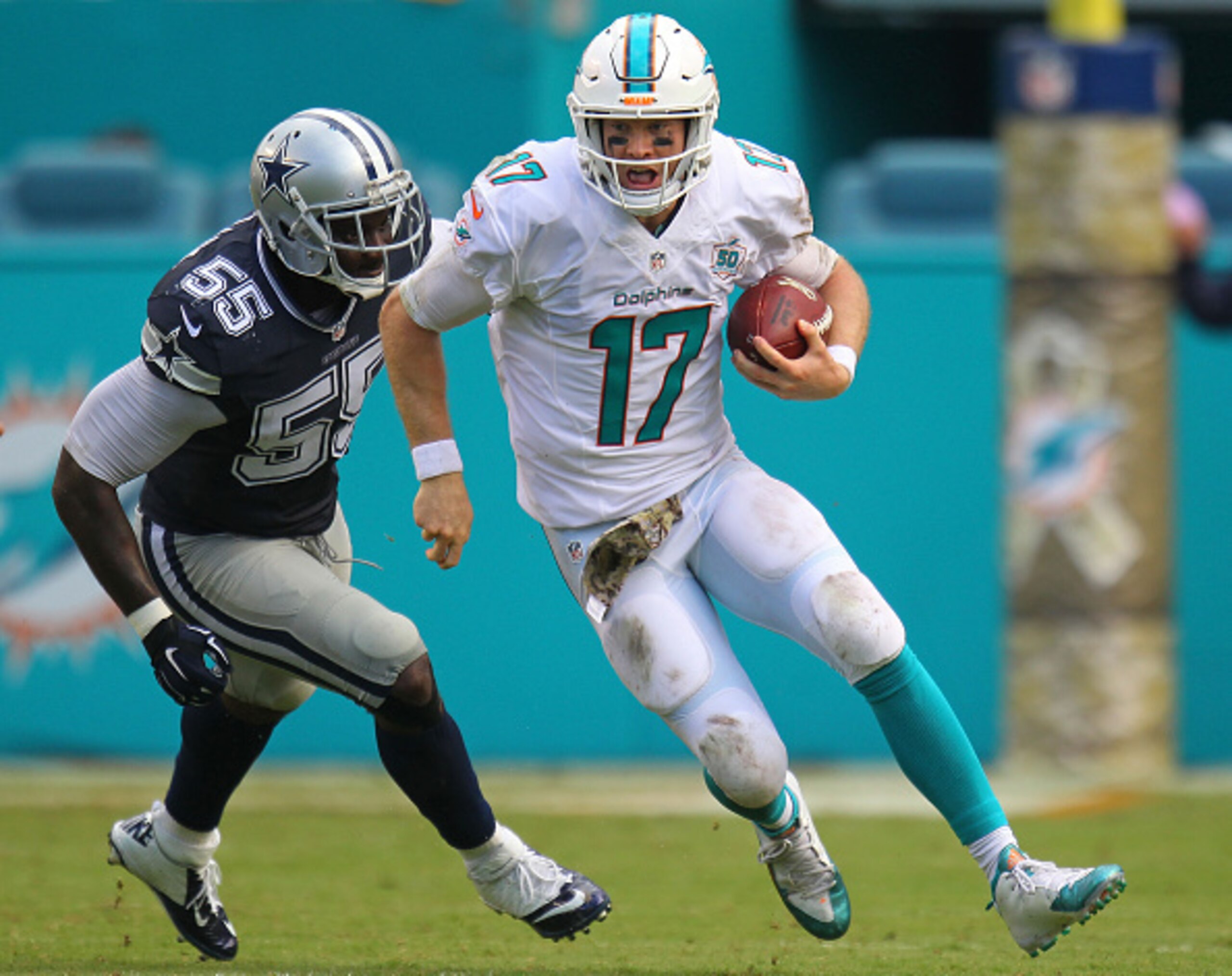 Ryan Tannehill looks to avoid Rolando McClain.