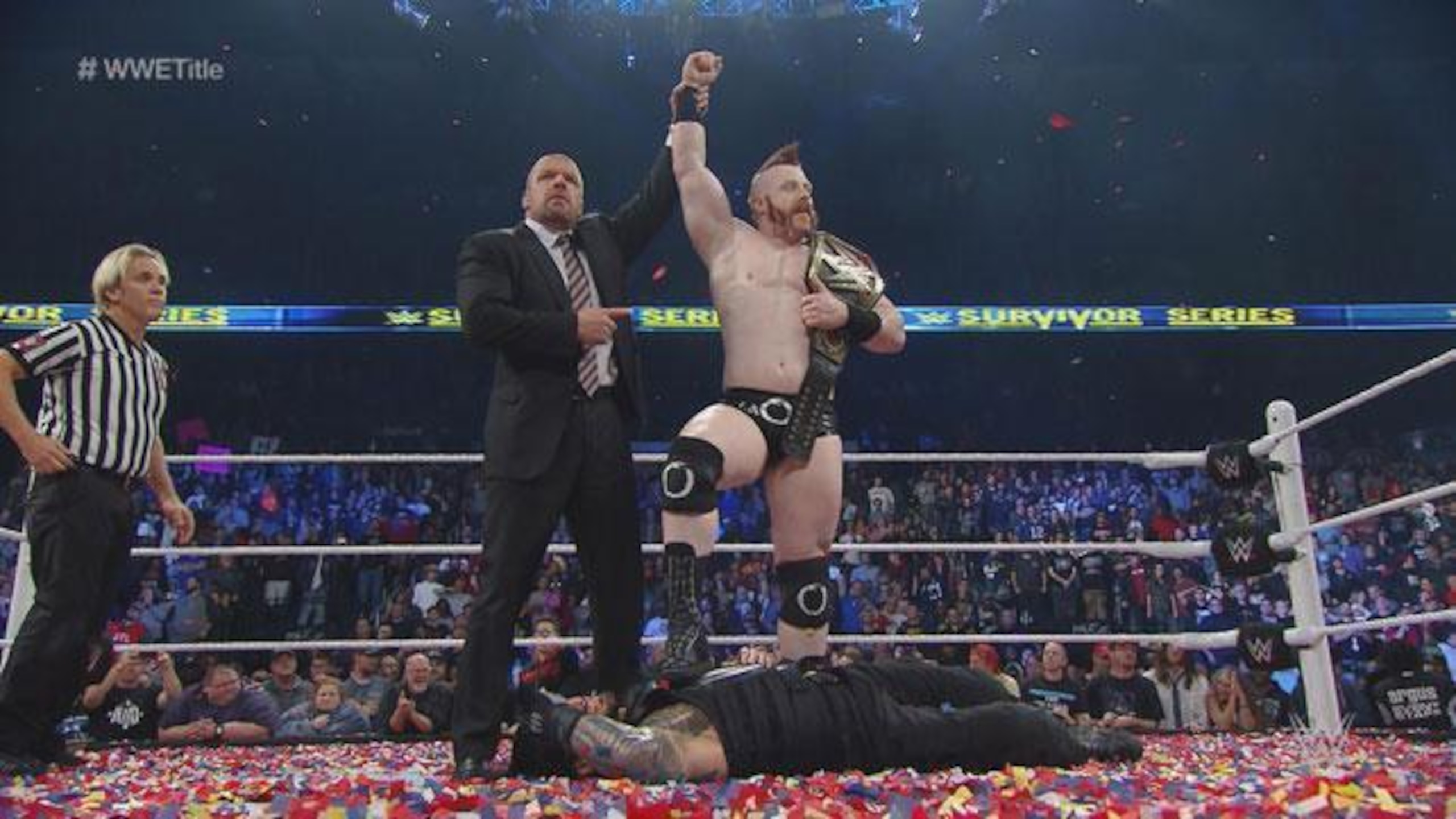 Sheamus stands over Roman Reigns after successfully cashing in his Money in the Bank contract.