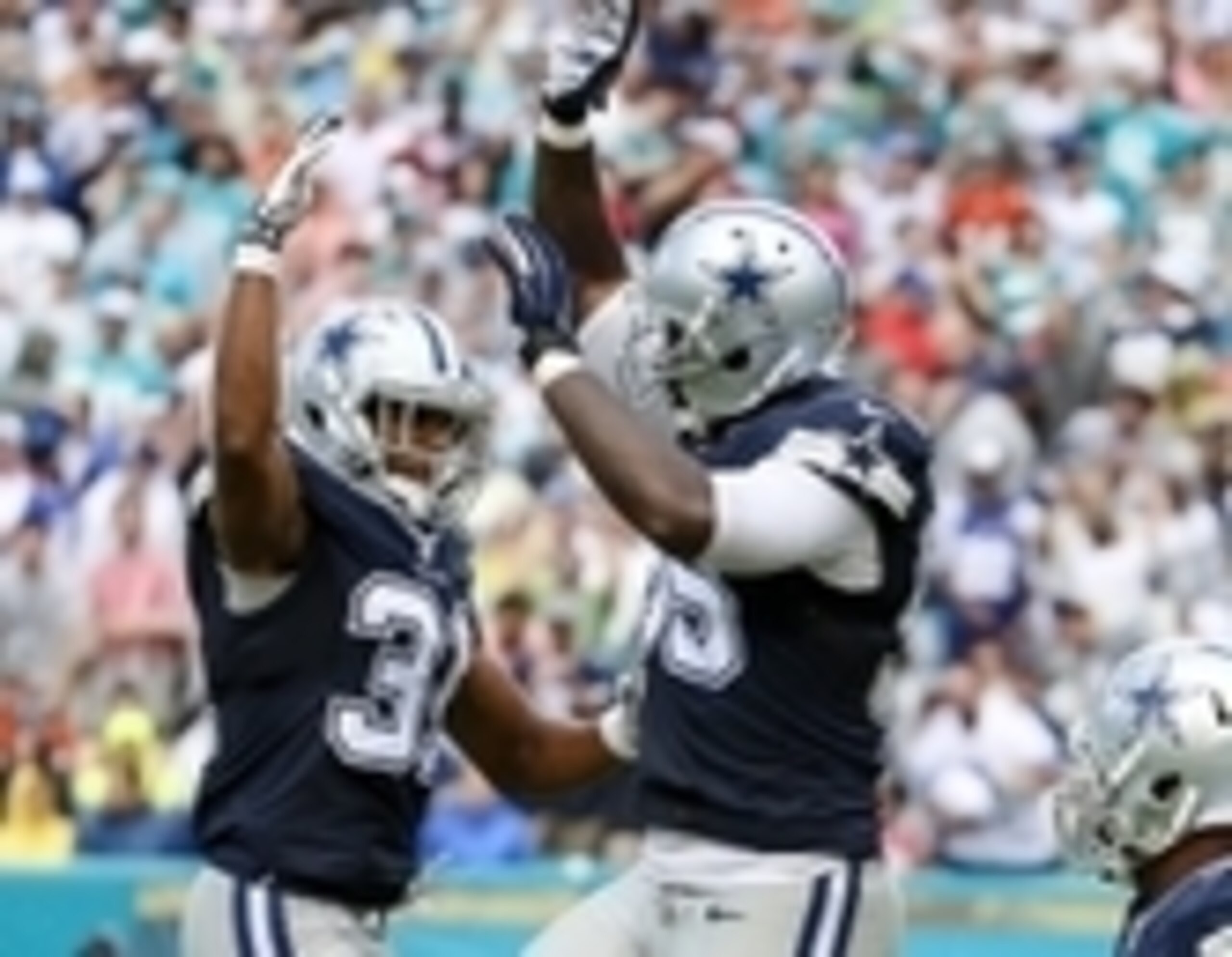 Nov 22, 2015; Miami Gardens, FL, USA; Dallas Cowboys free safety Byron Jones (left) celebrates after Dallas Cowboys middle linebacker Rolando McClain (right) scored an interception catch for a touchdown during the first half against the Miami Dolphins at 