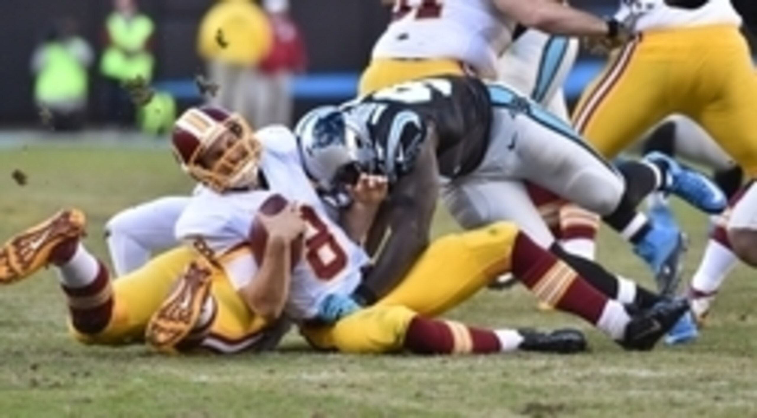 Nov 22, 2015; Charlotte, NC, USA; Washington Redskins quarterback Kirk Cousins (8) is sacked by Carolina Panthers defensive end Mario Addison (97) in the fourth quarter. The Panthers defeated the Redskins 44-16 at Bank of America Stadium. Mandatory Credit
