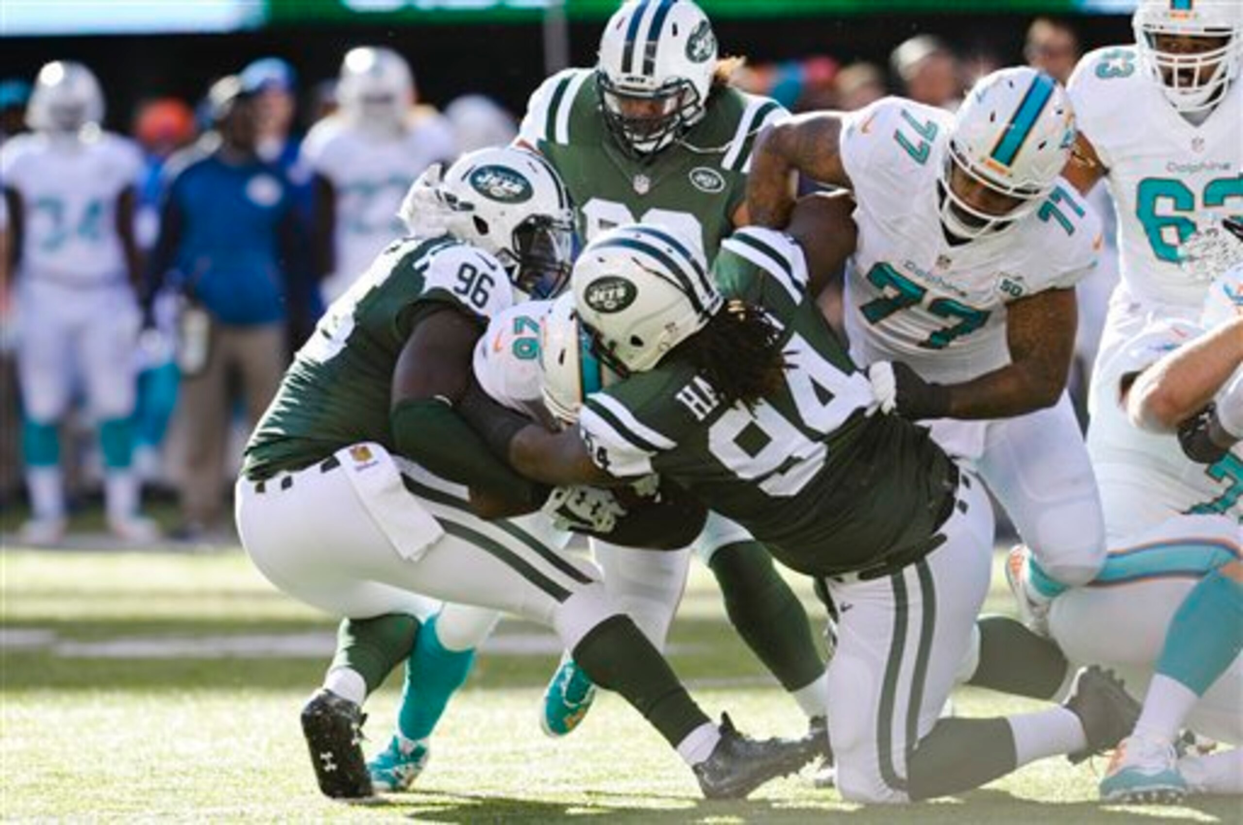 Muhammad Wilkerson (96) and Damon Harrison (94) tackle Dolphins running back Lamar Miller. Muhammad Wilkerson (96) and Damon Harrison (94) tackle Dolphins running back Lamar Miller.