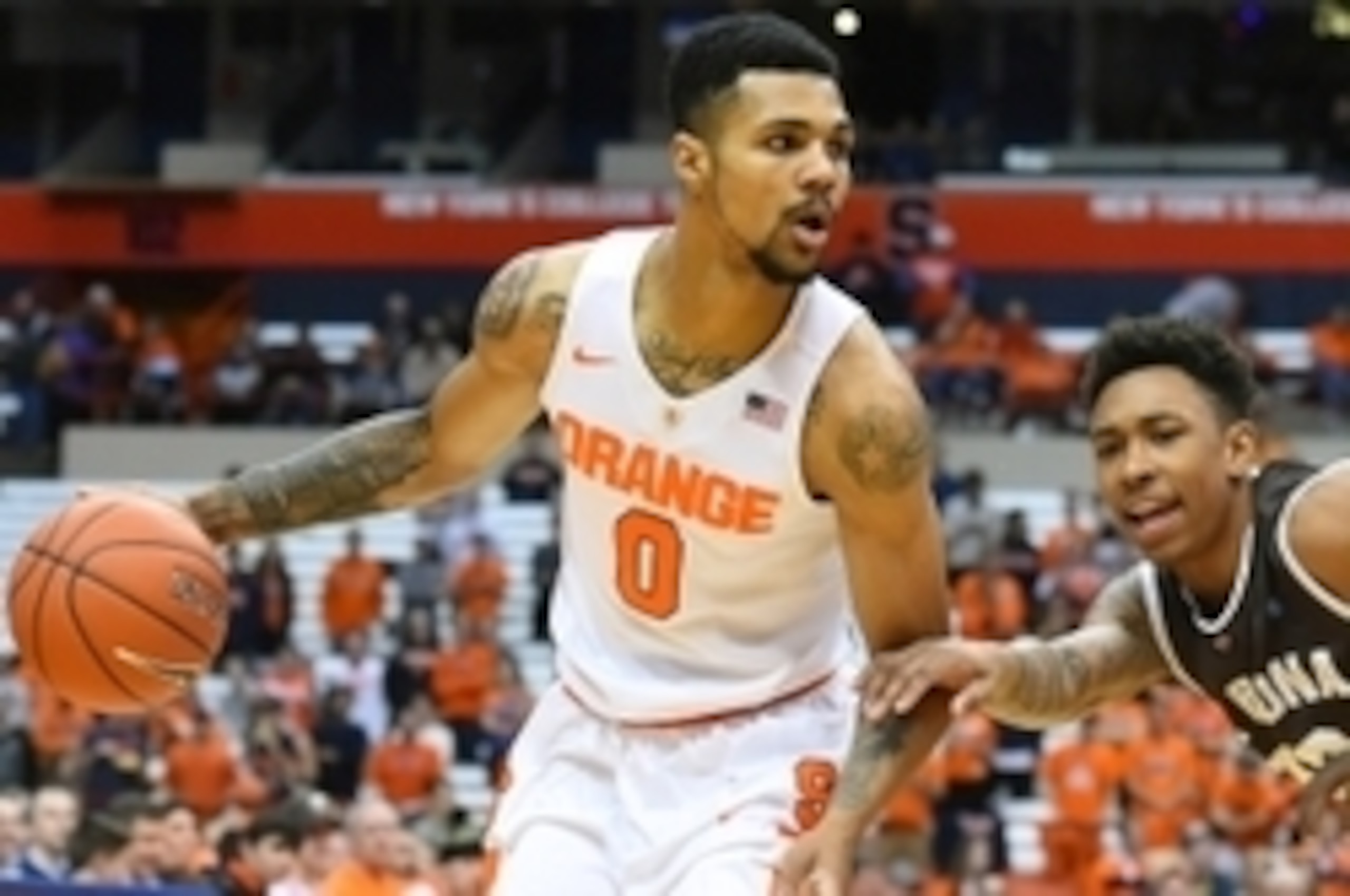 Nov 17, 2015; Syracuse, NY, USA; Syracuse Orange forward Michael Gbinije (0) controls the ball against the defense of St. Bonaventure Bonnies guard Jaylen Adams (10) during the first half at the Carrier Dome.  Syracuse defeated St. Bonaventure 79-66.  Man