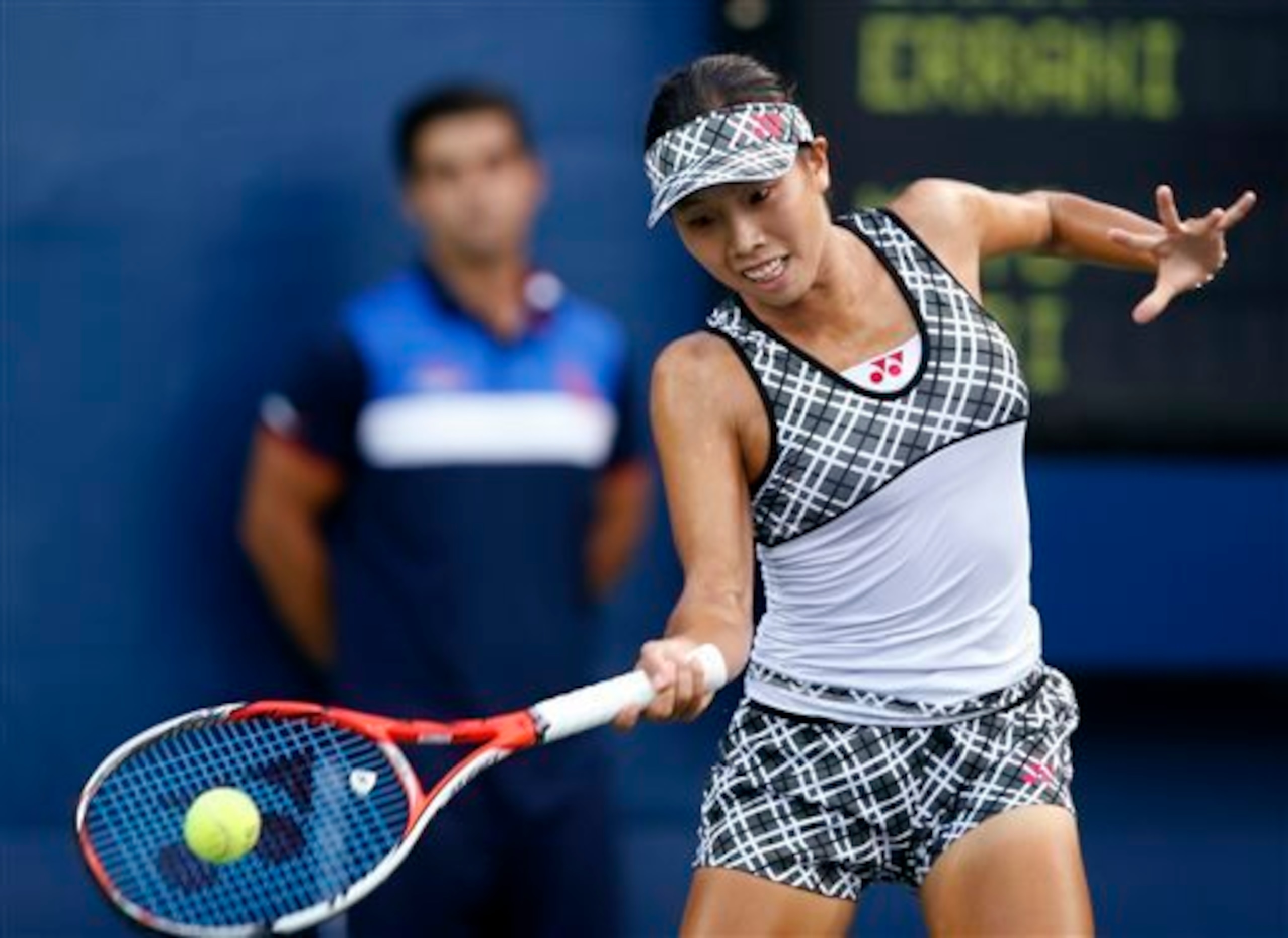 Mayo Hibi hits a forehand at the 2015 U.S. Open.