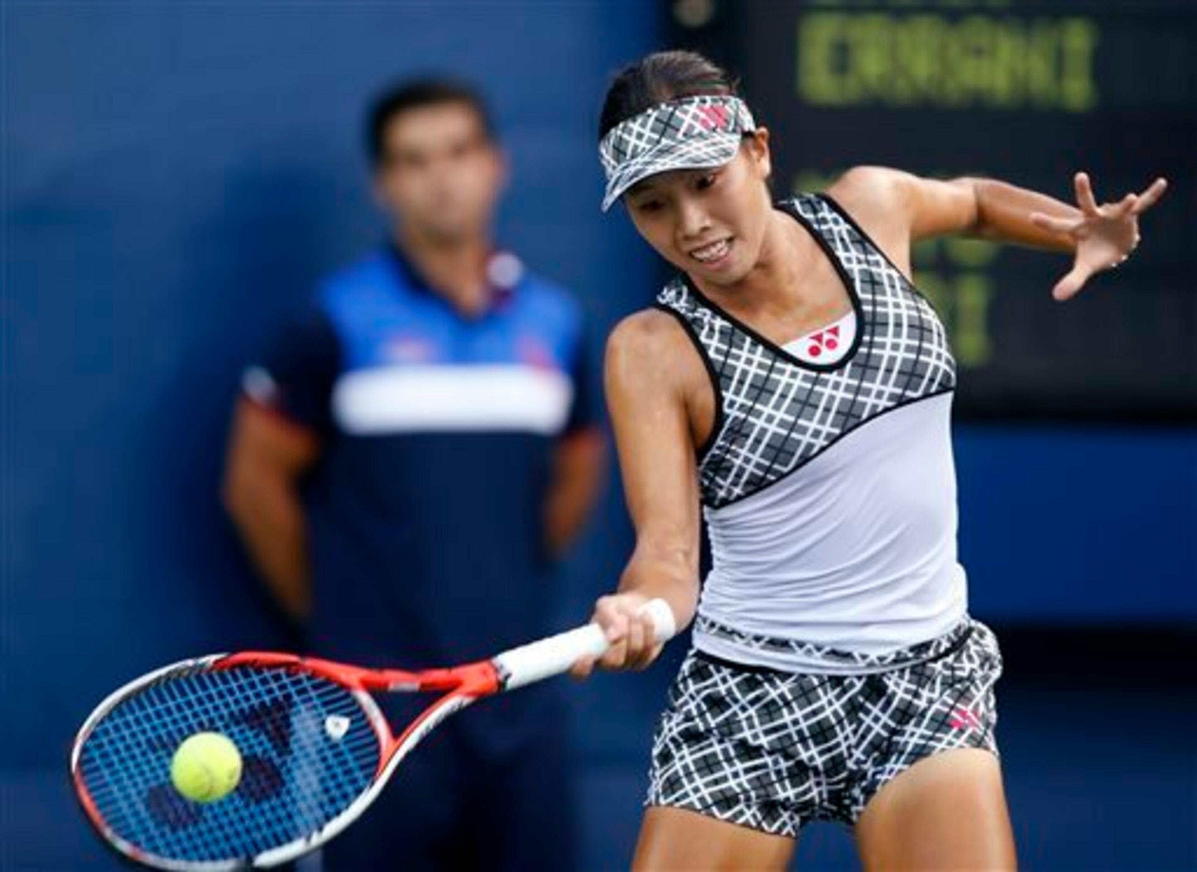 Mayo Hibi hits a forehand at the 2015 U.S. Open.