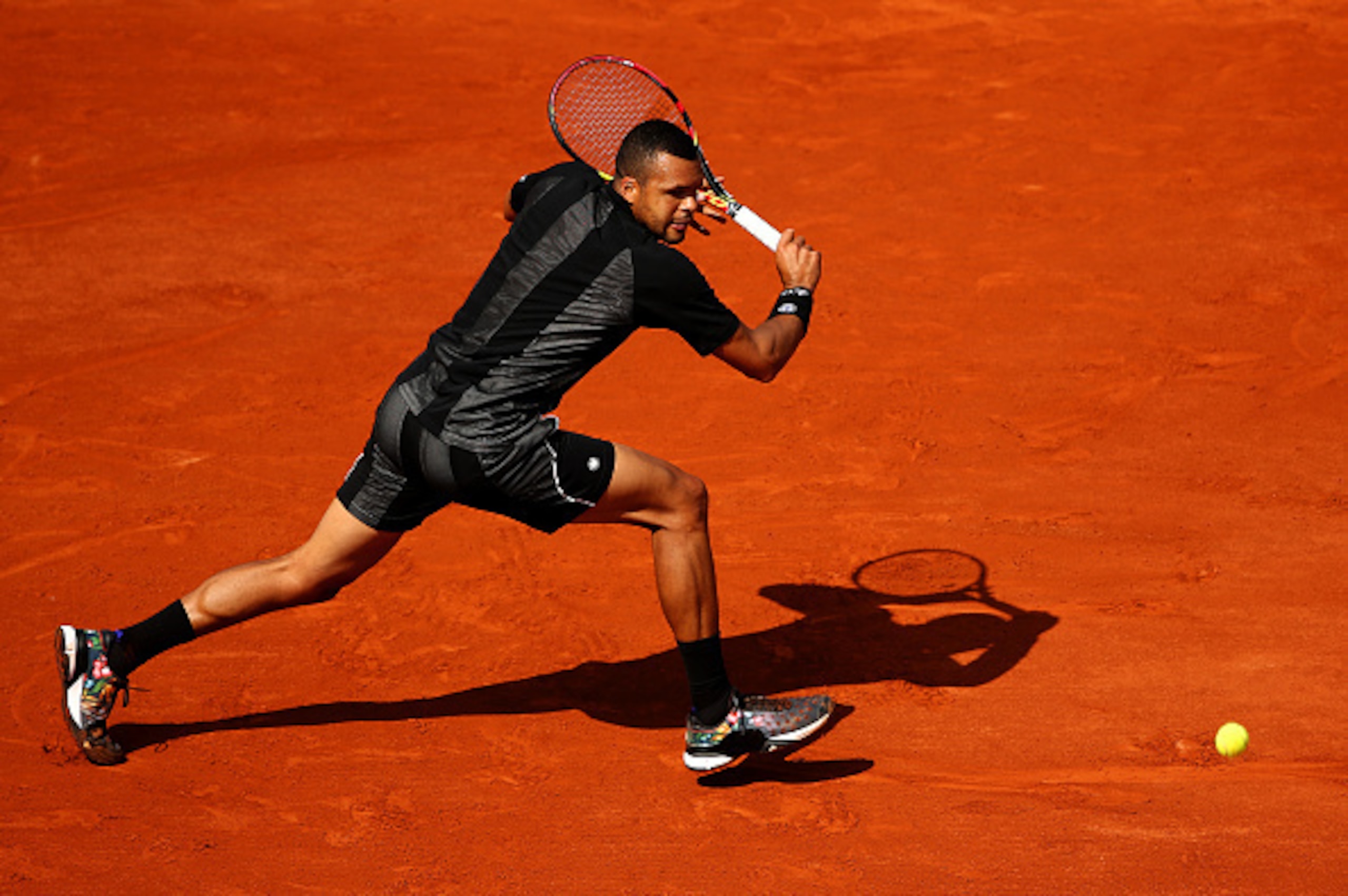 Jo-Wilfried Tsonga hits a backhand during the 2015 French Open.