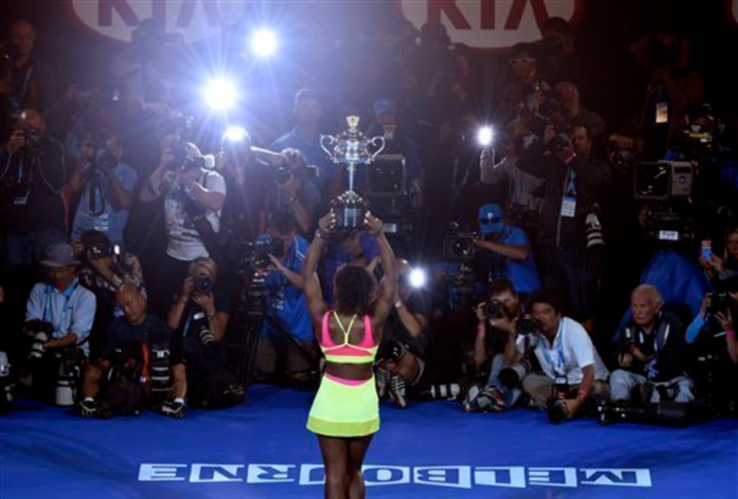 Serena Williams poses for photographers during the trophy ceremony of the 2015 Australian Open.