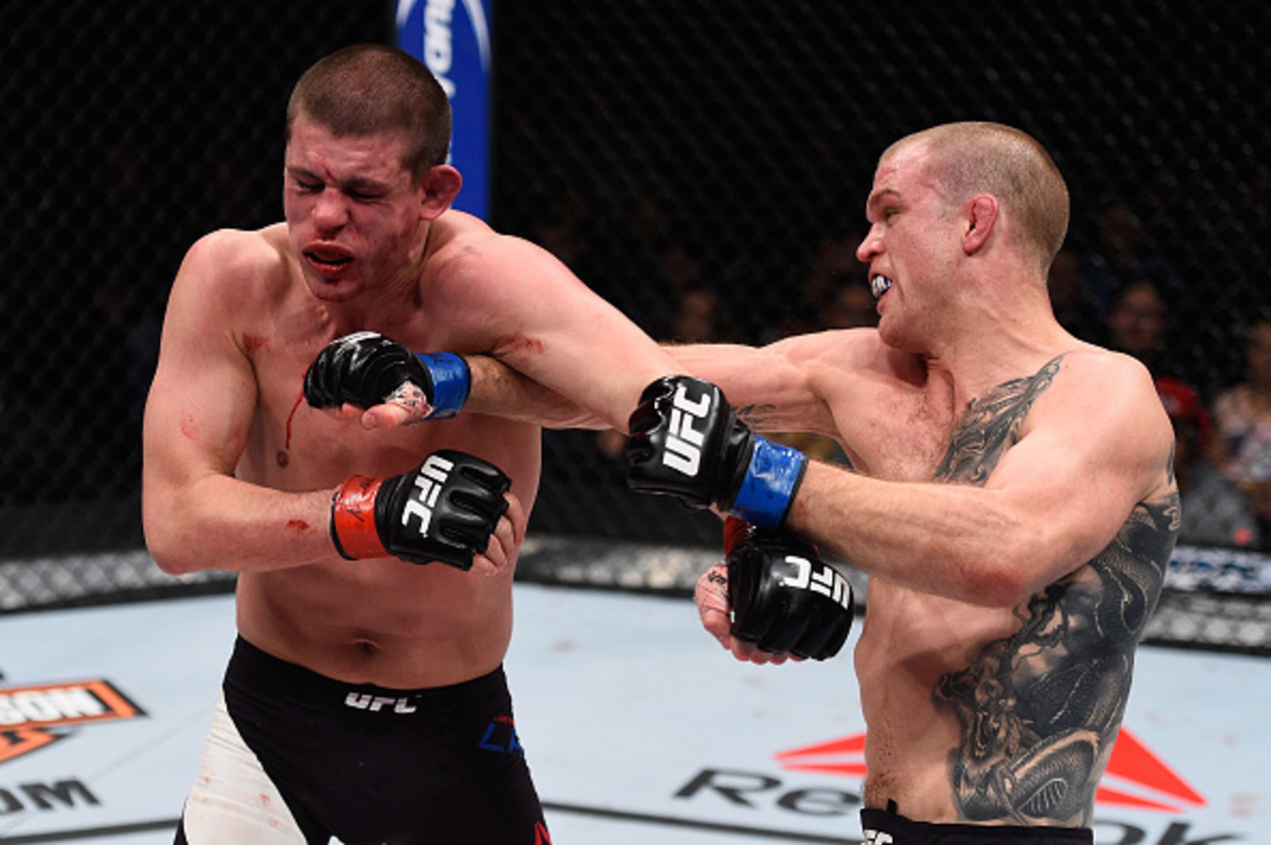 Evan Dunham (right) hits Joe Lauzon.