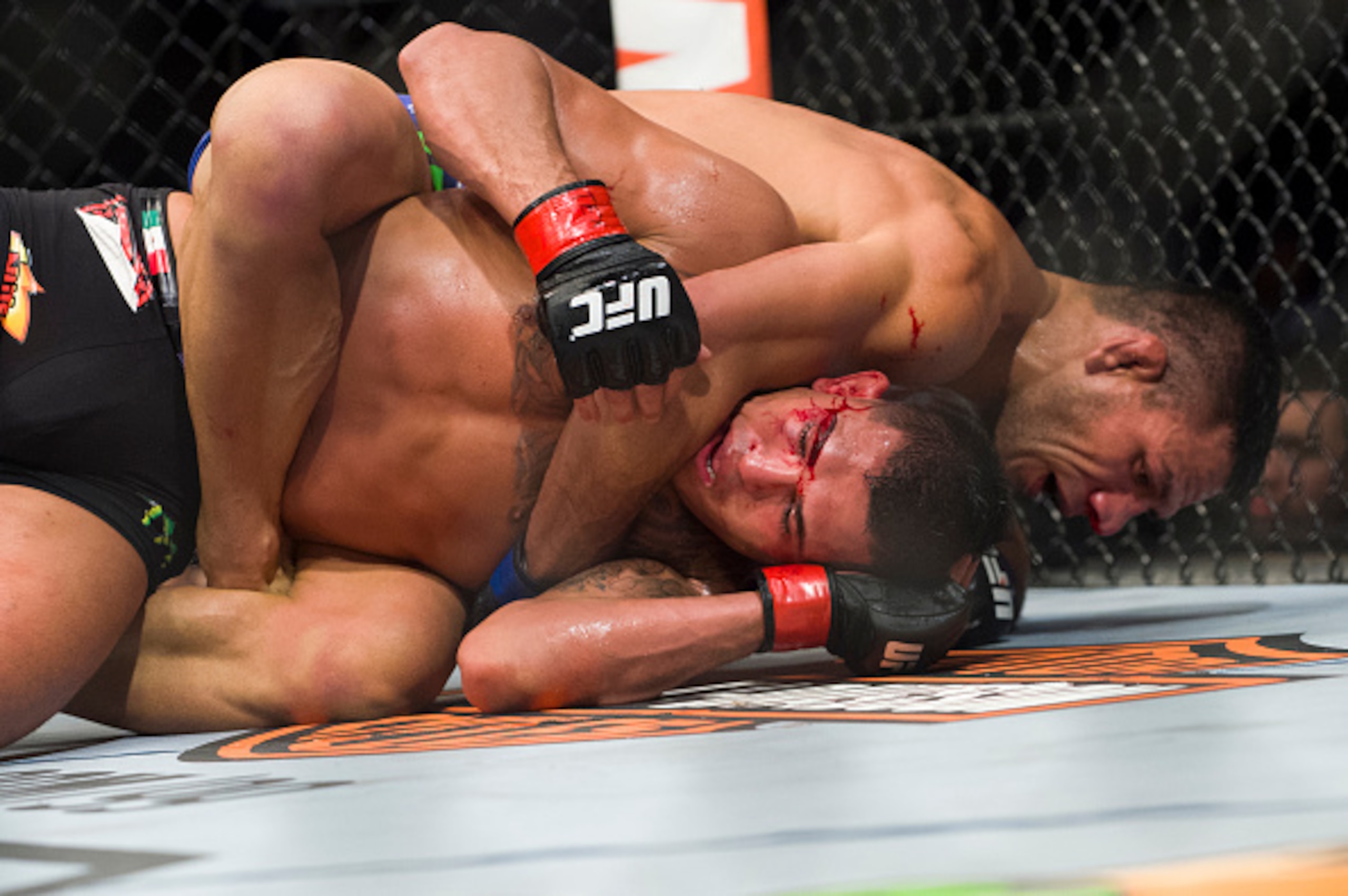 Dos Anjos attempts a submission against Pettis at UFC 185.