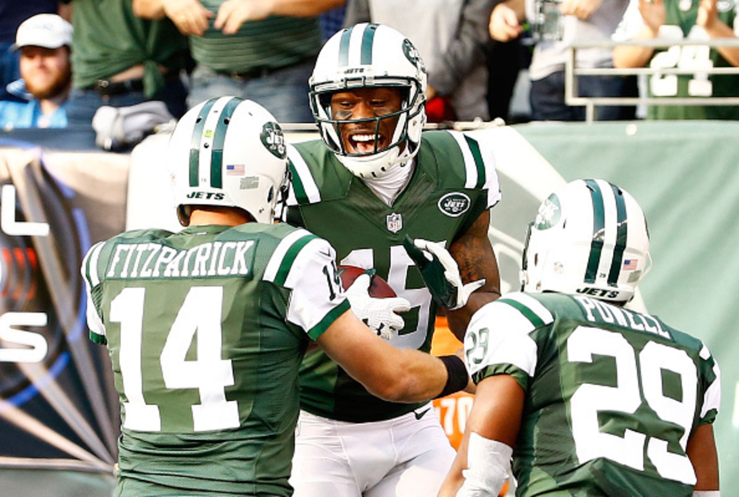 Ryan Fitzpatrick (14), Brandon Marshall (15) and Bilal Powell (29) celebrate a touchdown against the Titans.