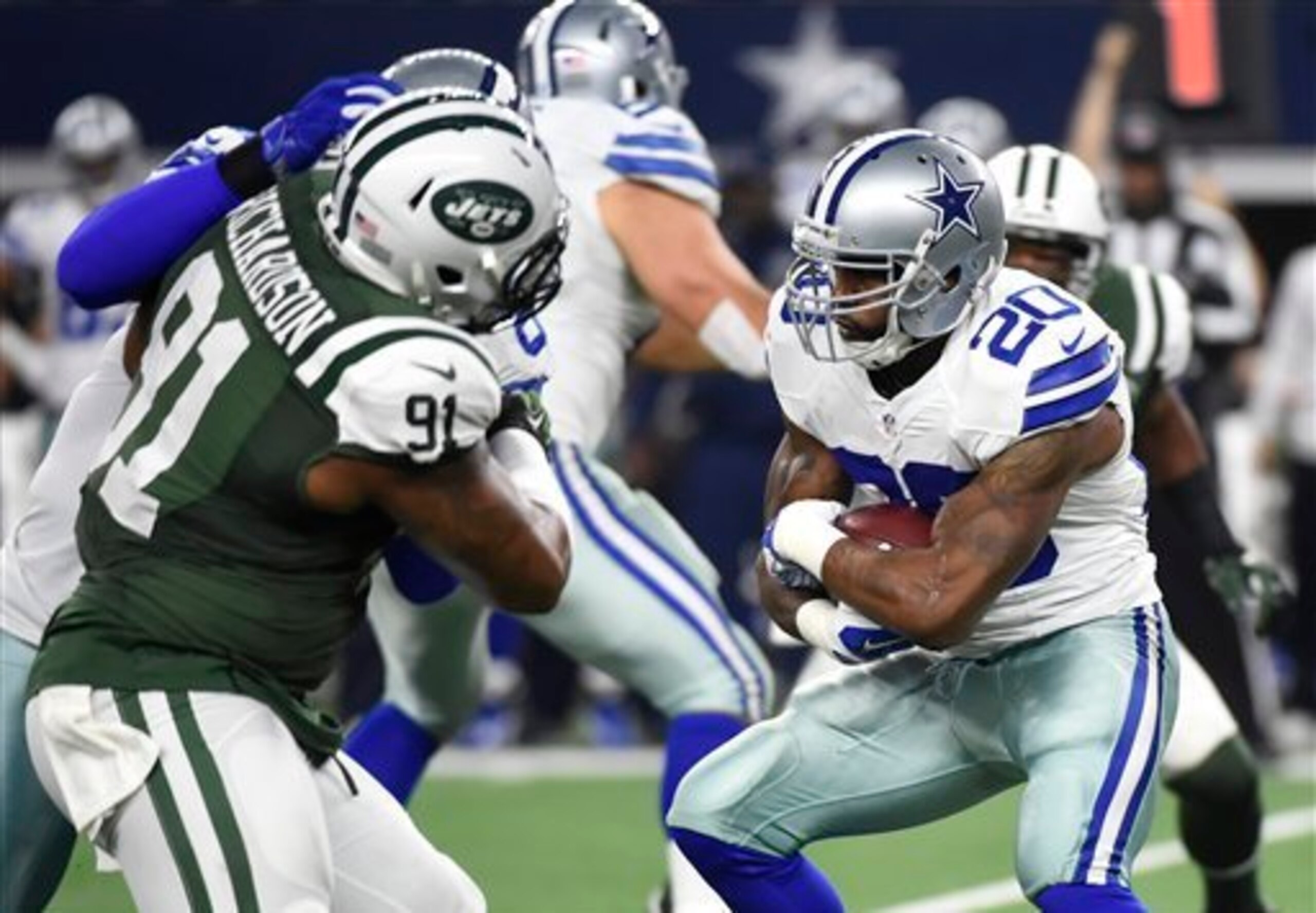 Sheldon Richardson (91) fights off a block to tackle Darren McFadden (20).