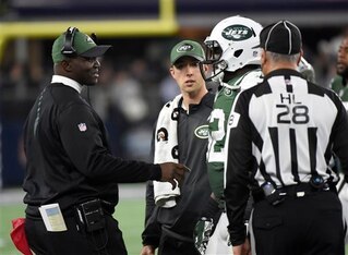 Todd Bowles (left) talks to an injured David Harris (52).