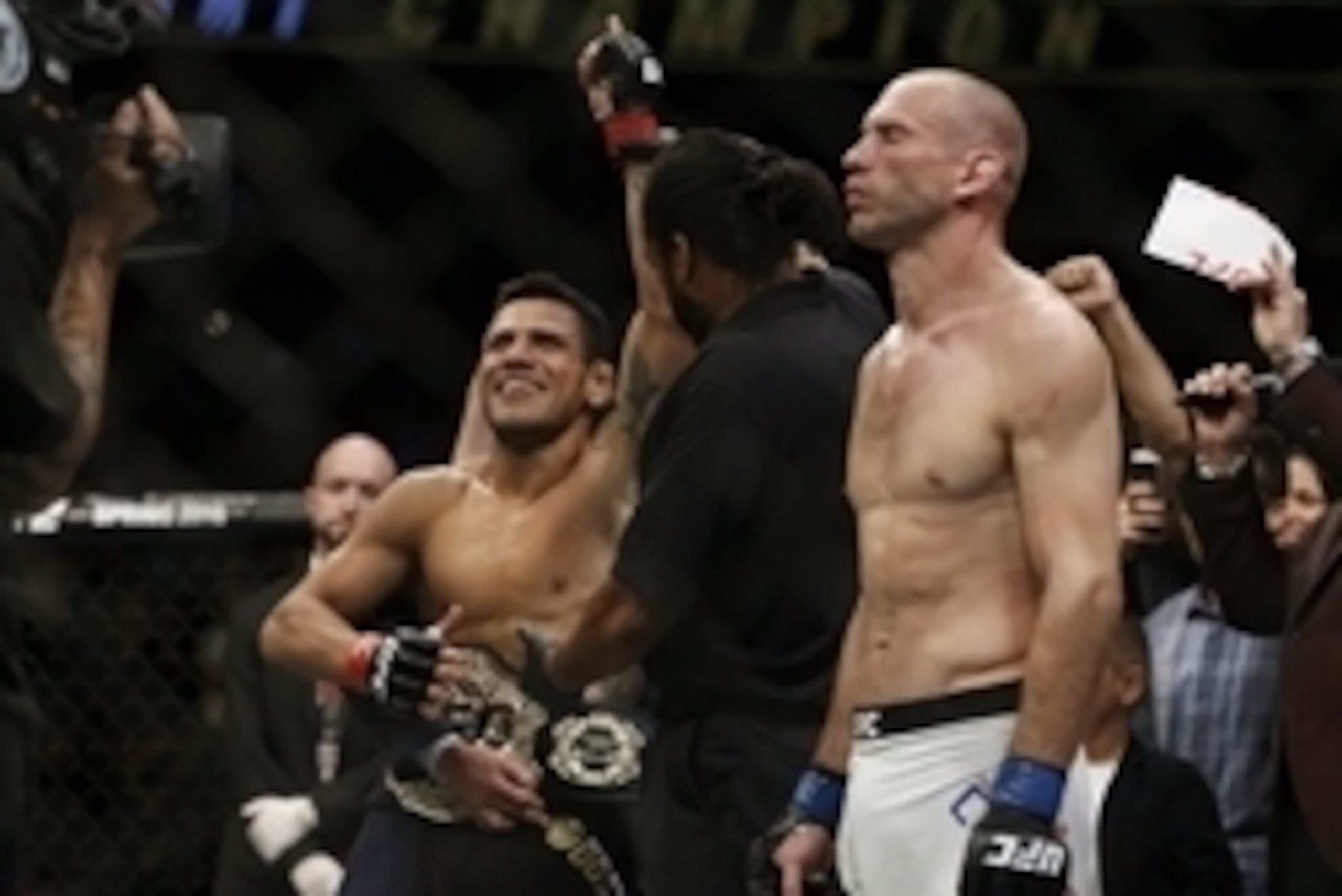 Rafael dos Anjos gets his hand raised as the official result is read following a dominant title defense against Donald Cerrone.
