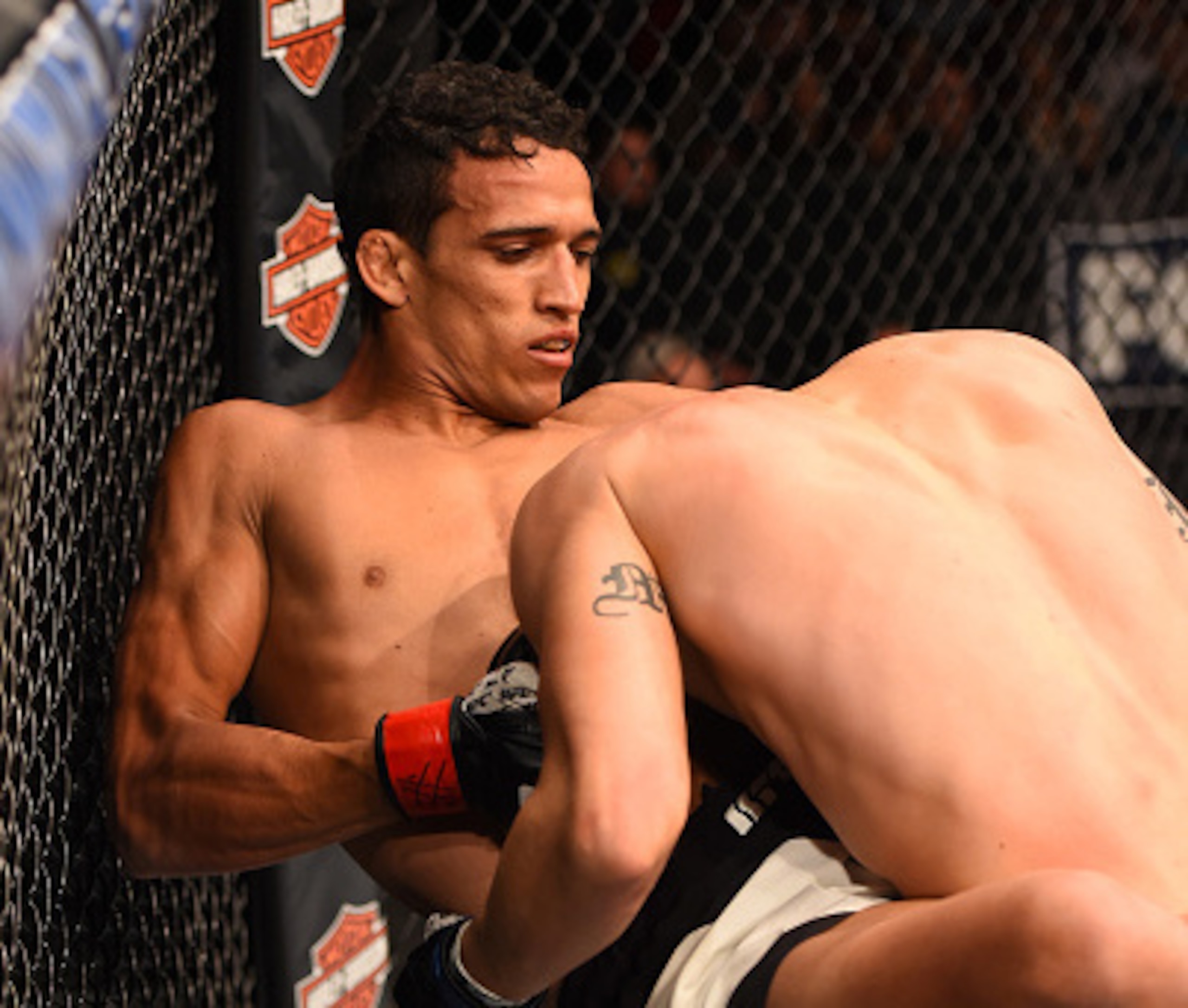 Charles Oliveira locks in a guillotine choke on Myles Jury to force the tap.