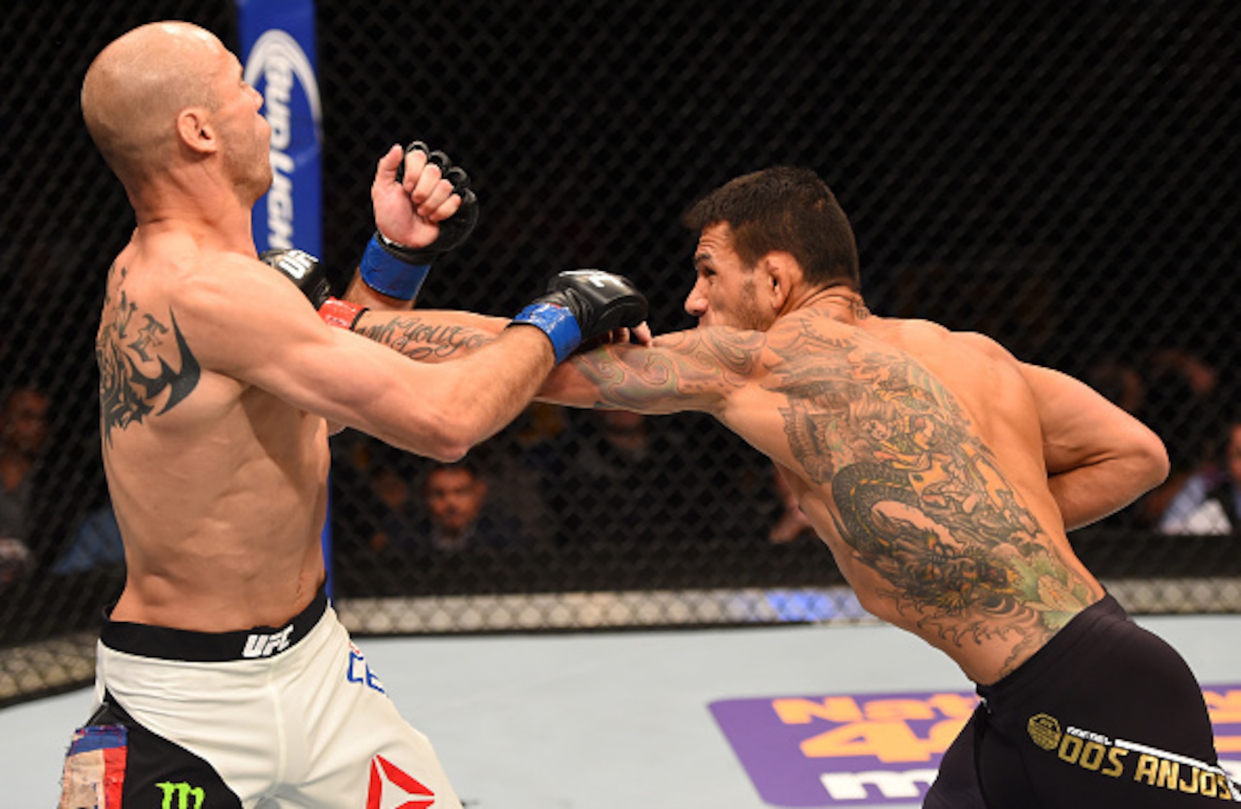 ORLANDO, FL - DECEMBER 19:   (R-L) Rafael dos Anjos punches Donald Cerrone in their UFC lightweight title bout during the UFC Fight Night event at the Amway Center on December 19, 2015 in Orlando, Florida. (Photo by Josh Hedges/Zuffa LLC/Zuffa LLC via Get