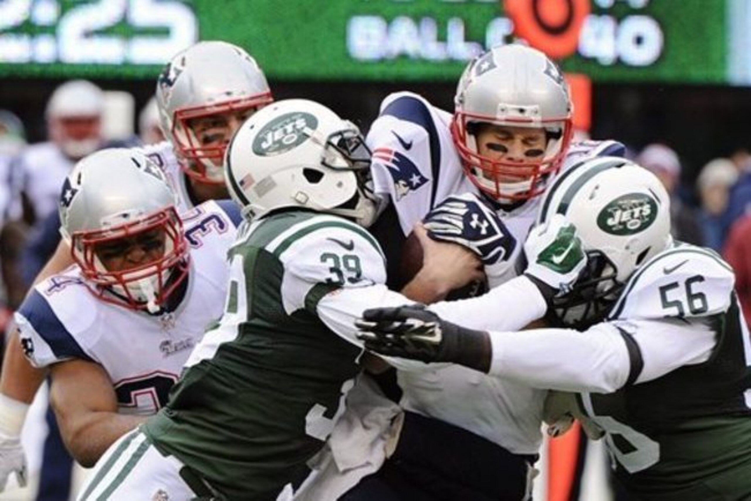Antonio Allen (39) and Demario Davis (56) sack Patriots quarterback Tom Brady.