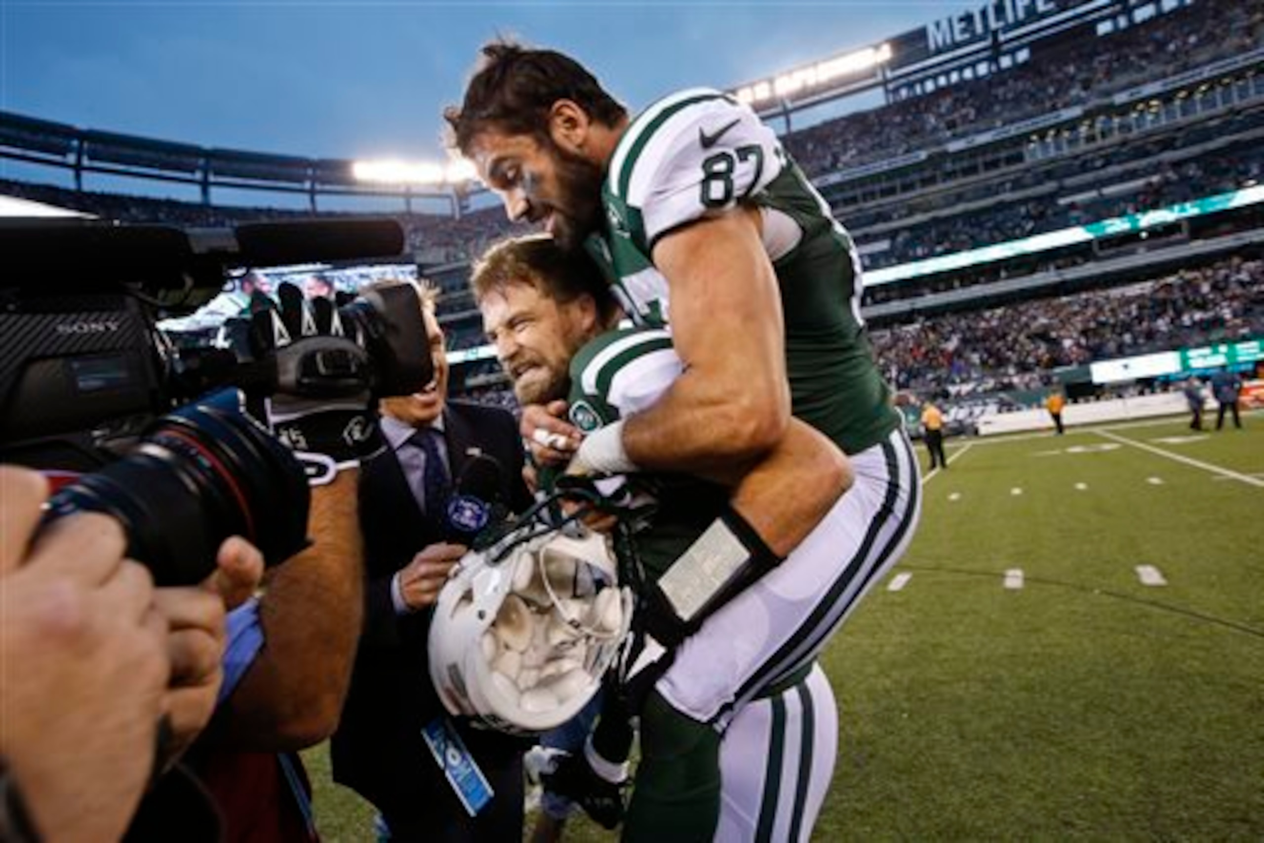 Ryan Fitzpatrick (bottom) and Eric Decker (87) celebrate the Jets victory.