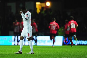 EXETER, ENGLAND - JANUARY 08:  Christian Benteke of Liverpool (9) reacts as Tom Nichols of Exeter City scores the opening goal during the Emirates FA Cup third round match between Exeter City and Liverpool at St James Park on January 8, 2016 in Exeter, En