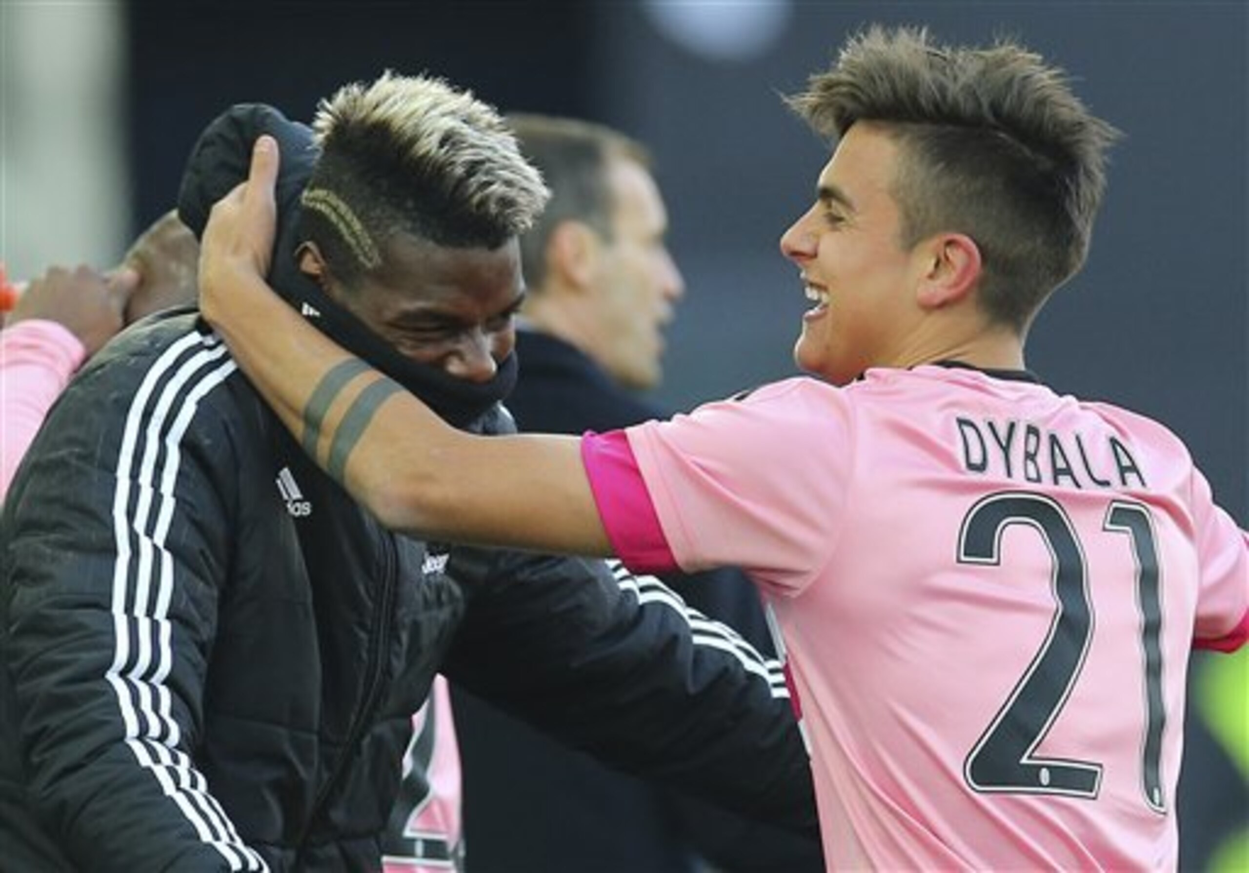 Juventus' Paulo Dybala, right, celebrates with teammate Paul Pogba after scoring during the Serie A soccer match between Udinese and Juventus at the Friuli Stadium in Udine, Italy, Sunday, Jan. 17, 2016. (AP Photo/Paolo Giovannini)