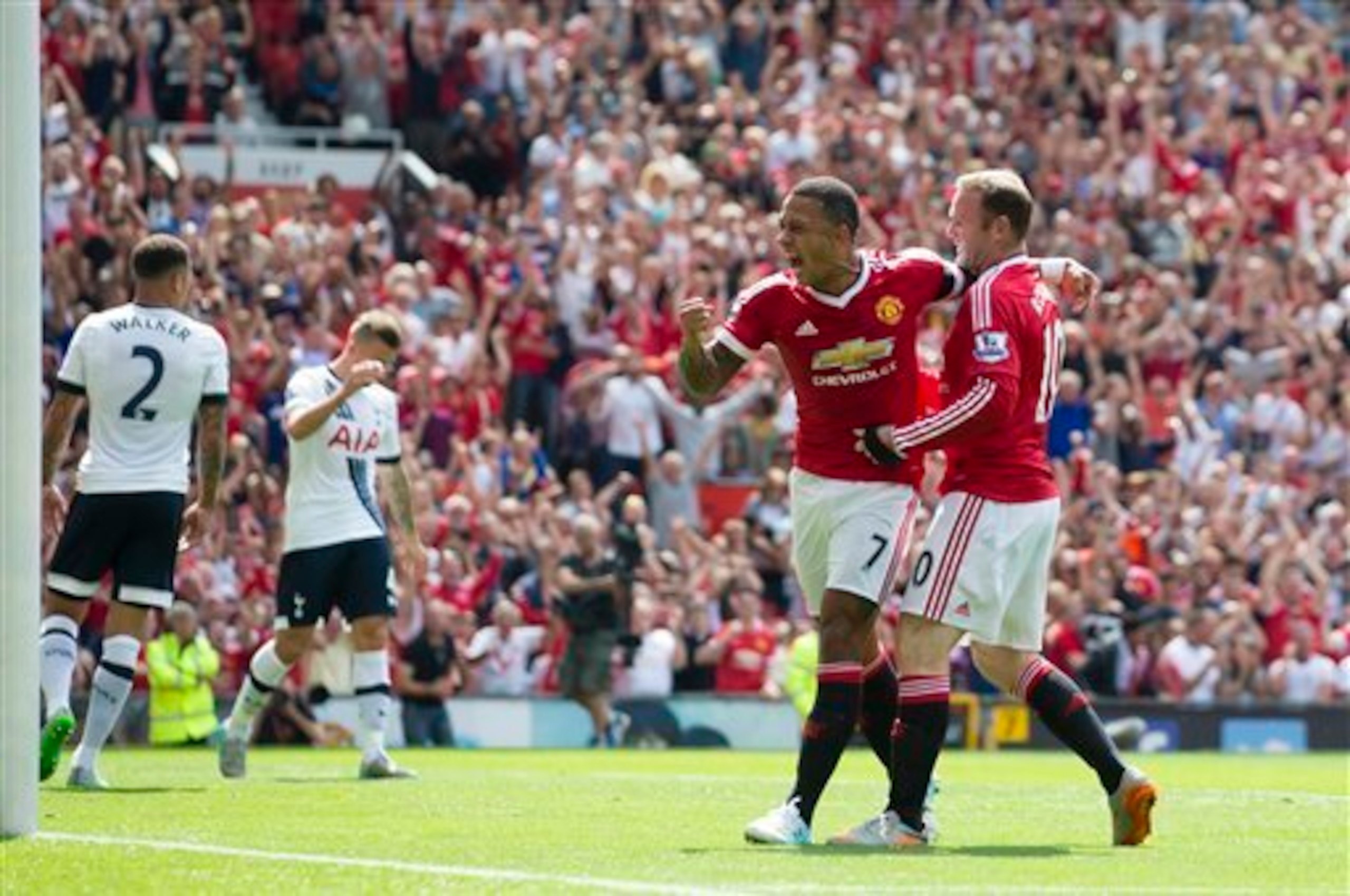 Memphis and Rooney celebrate during United's opening-day win over Spurs.