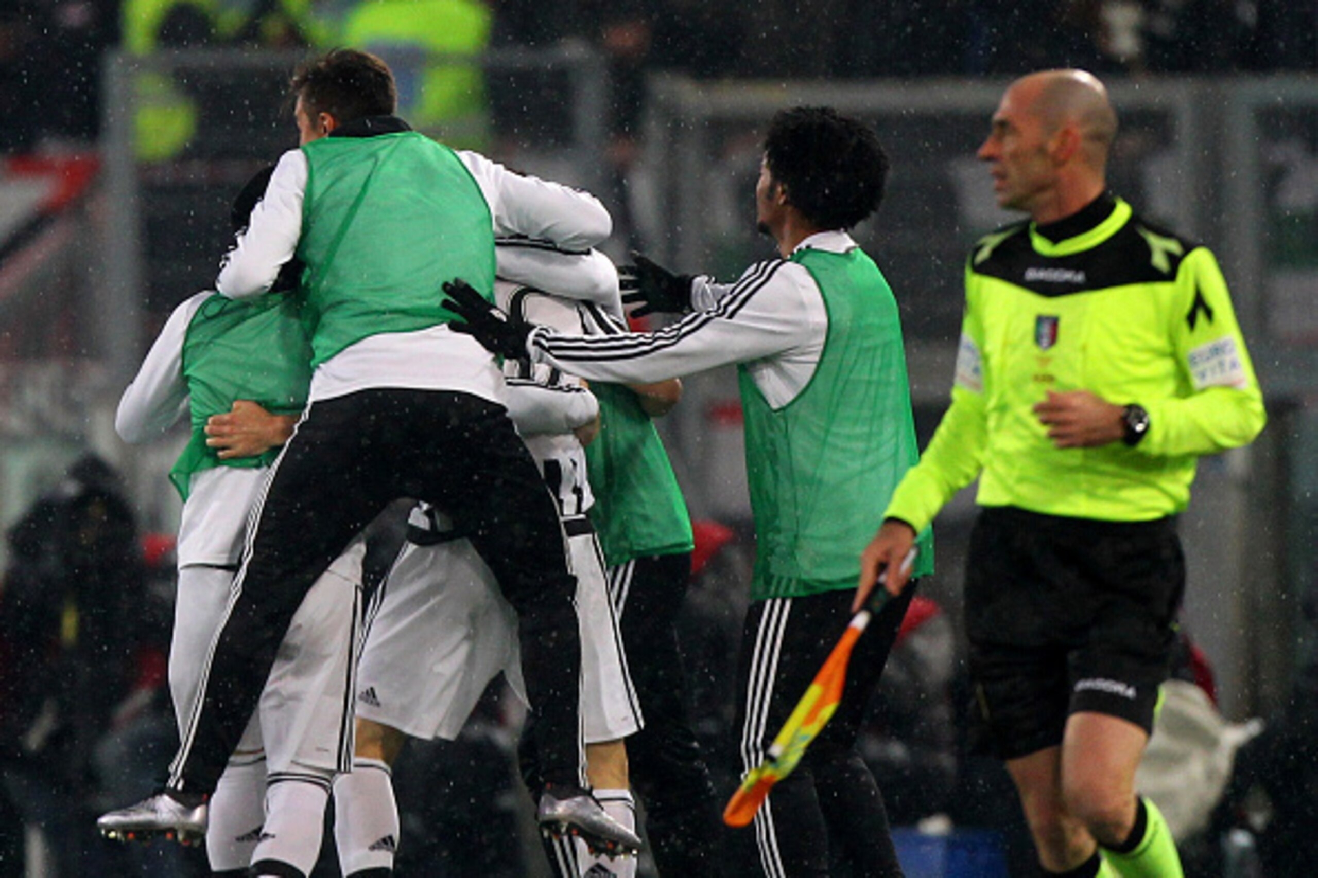 Juventus subs pile onto Stephan Lichtsteiner after he scored the lone goal of their 1-0 victory.