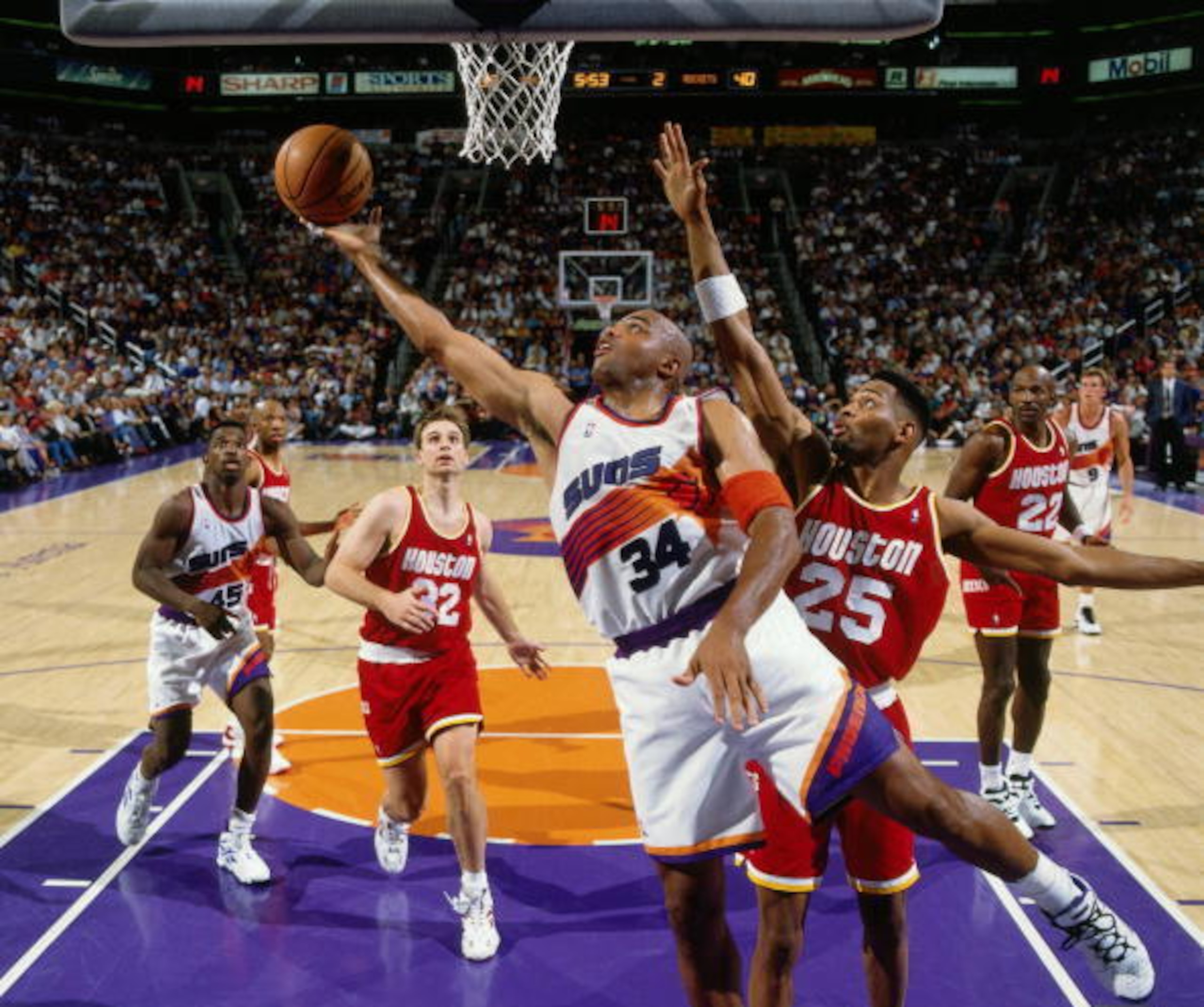 PHOENIX - MAY 16:  Charles Barkley #34 of the Phoenix Suns shoots a layup against Robert Horry #25 of the Houston Rockets in Game Five of the Western Conference Semifinals during the 1995 NBA Playoffs at the American West Arena on May 16, 1995 in Phoenix,