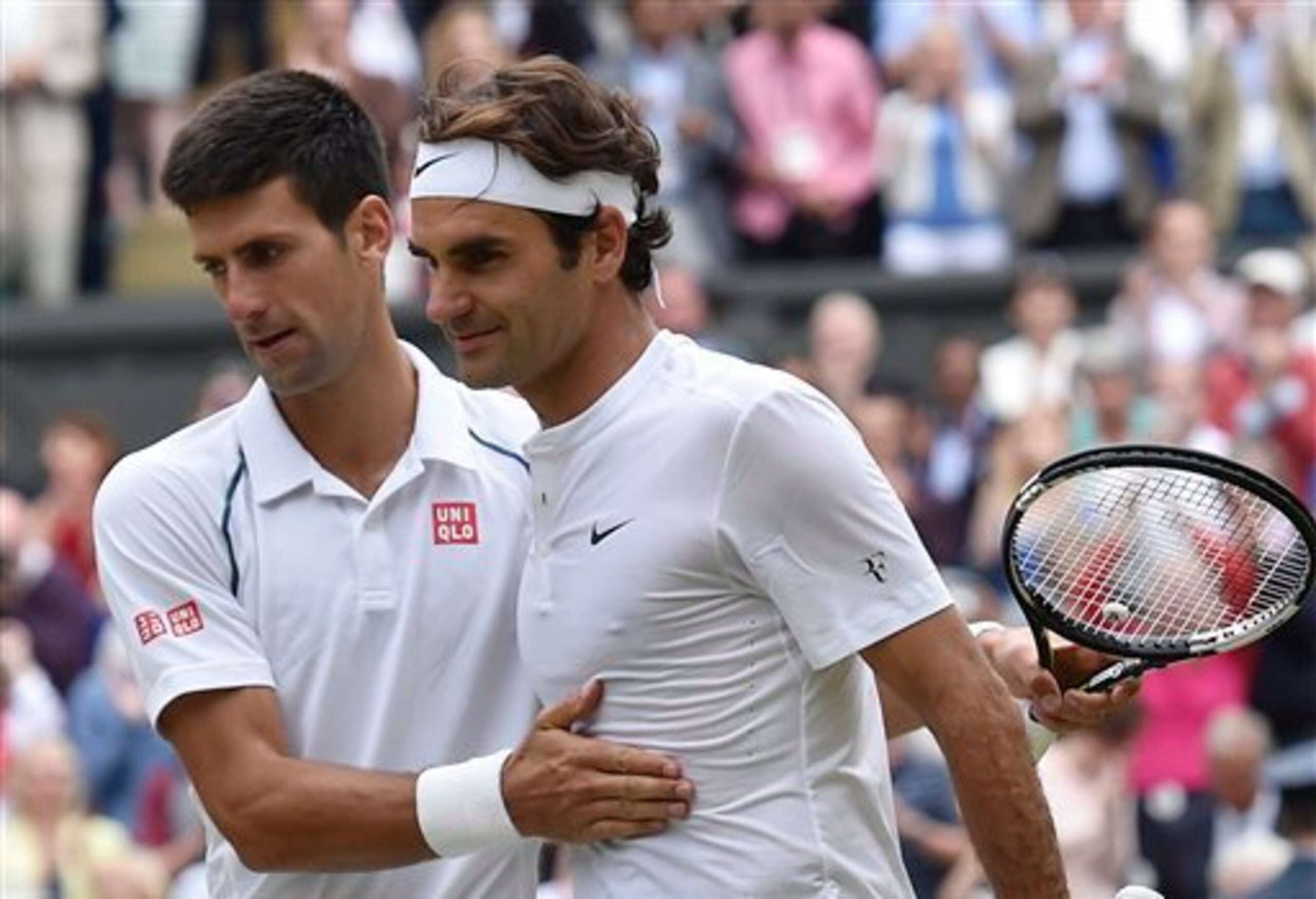 Novak Djokovic greets Roger Federer at the net after the Serbian won their match in the finals at Wimbledon in 2015.