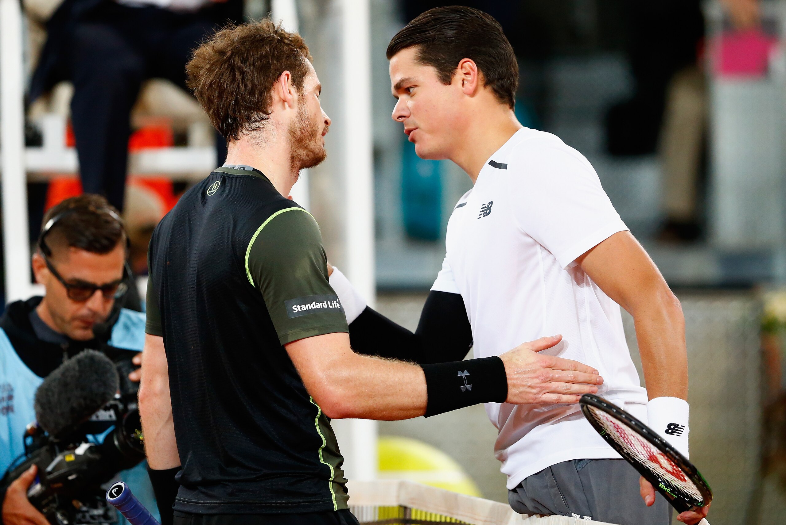 Andy Murray and Milos Raonic greet at the net after a match in Madrid in 2015.